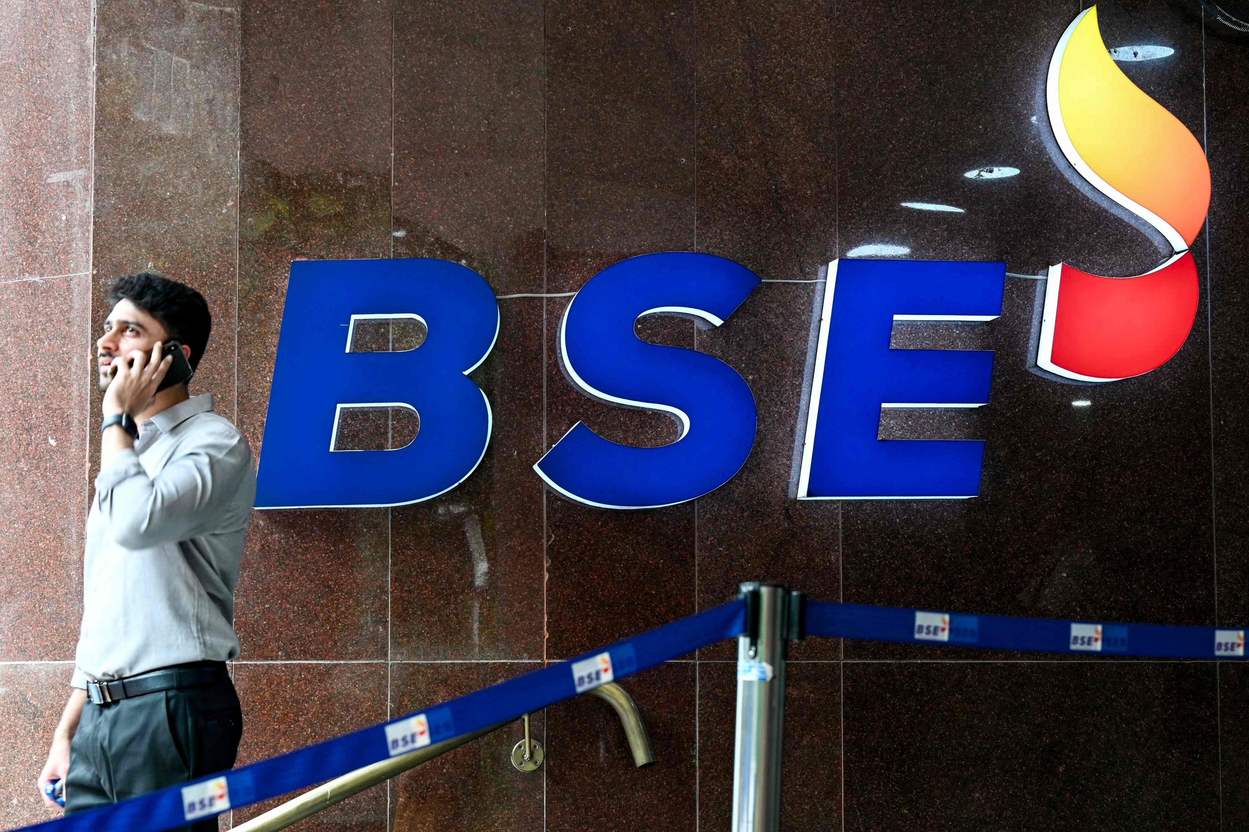 A man attends to a phone call at the BSE building in Mumbai on August 5. Photo: AFP