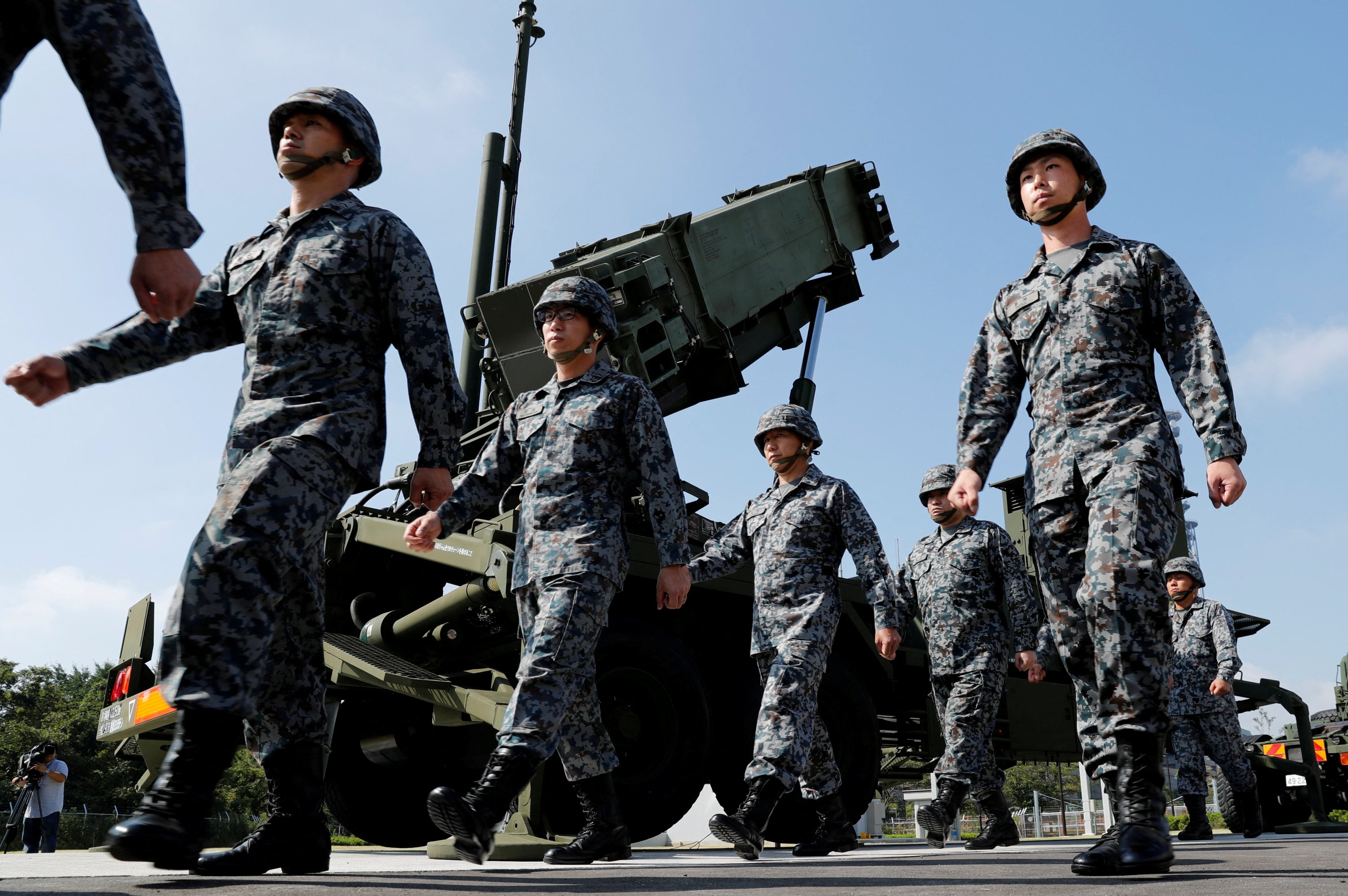 Japanese soldiers walk past a US Patriot missile battery during a troop review in Tokyo. Photo: Reuters