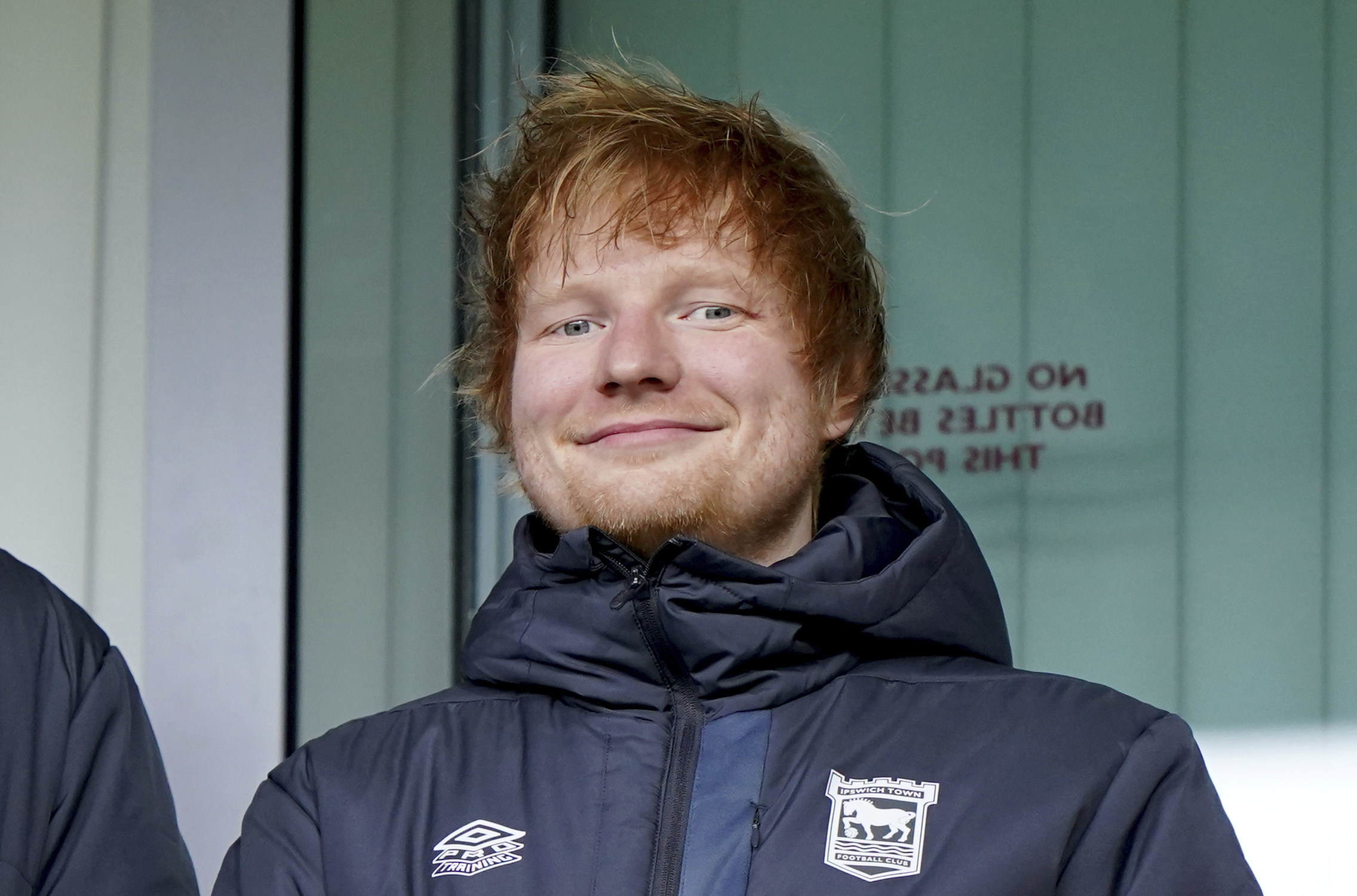 New Ipswich Town minority shareholder and life-long fan Ed Sheeran in the stands before a Championship match at Portman Road.   Photo: AP