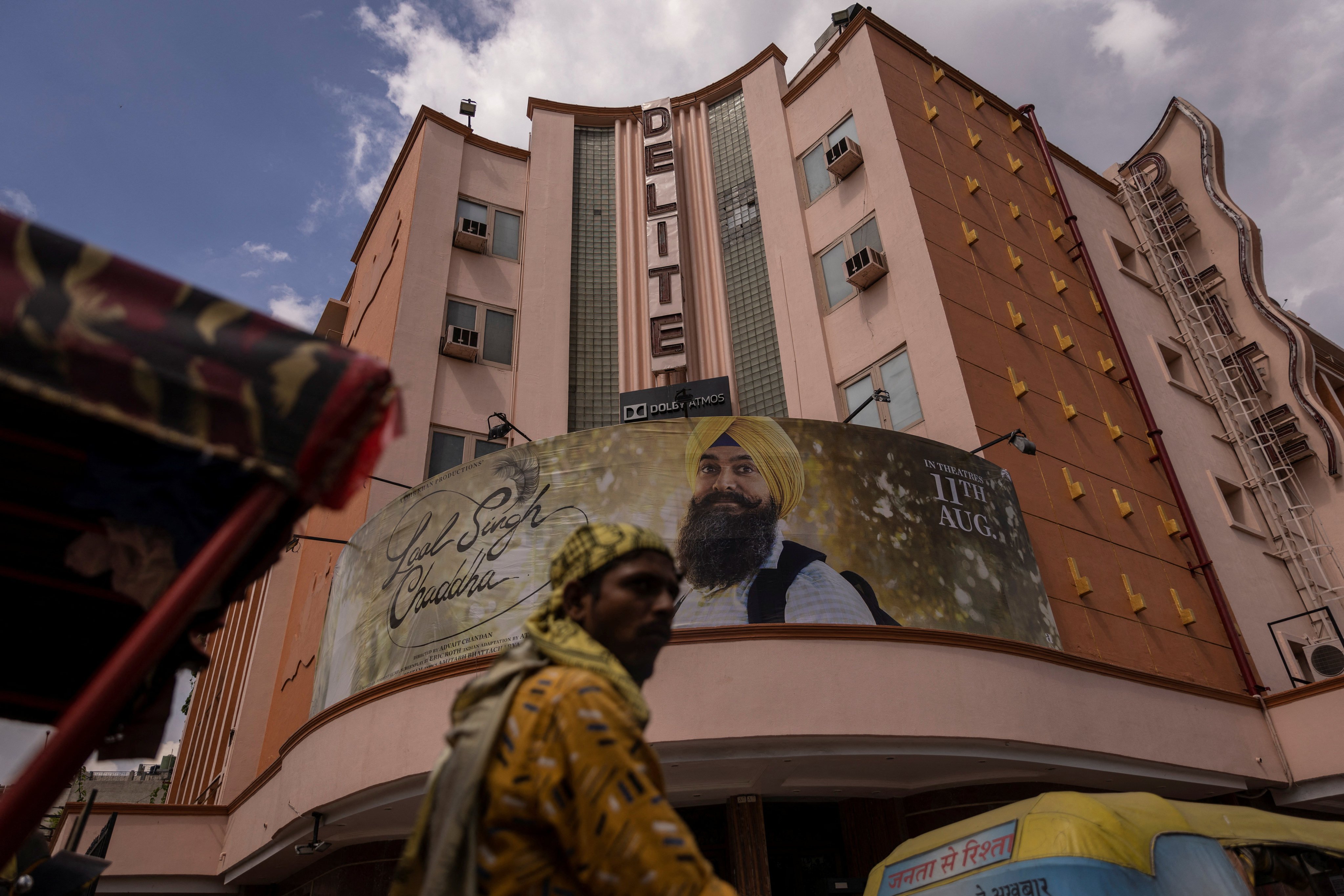 A rickshaw-puller stands outside a cinema in New Delhi in 2022. More than 1,000 of India’s single-screen cinemas have closed over the past decade. Photo: Reuters