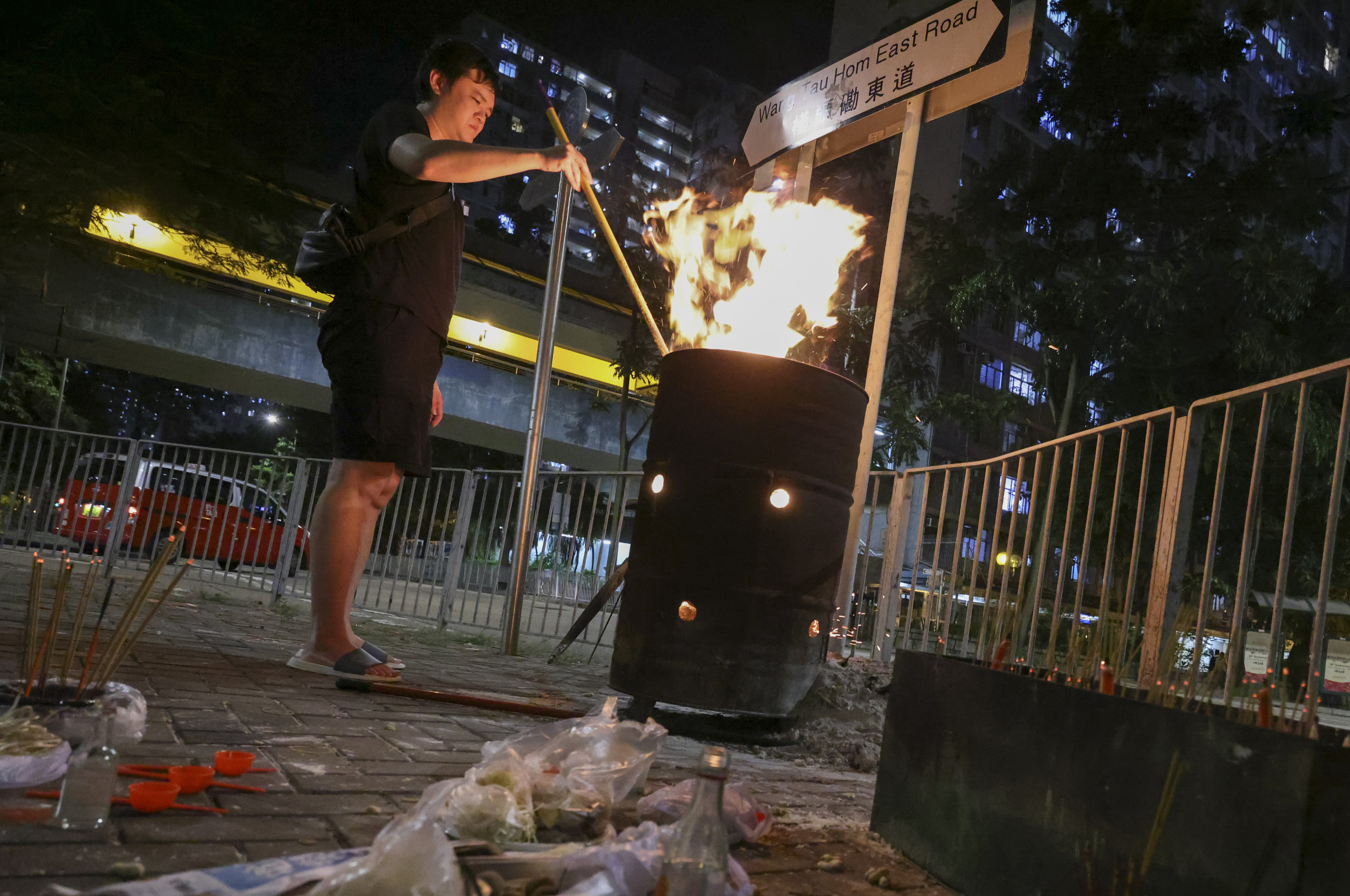 A worshipper burns paper offerings during the Hungry Ghost Festival in Lok Fu, Hong Kong. Photo: May Tse