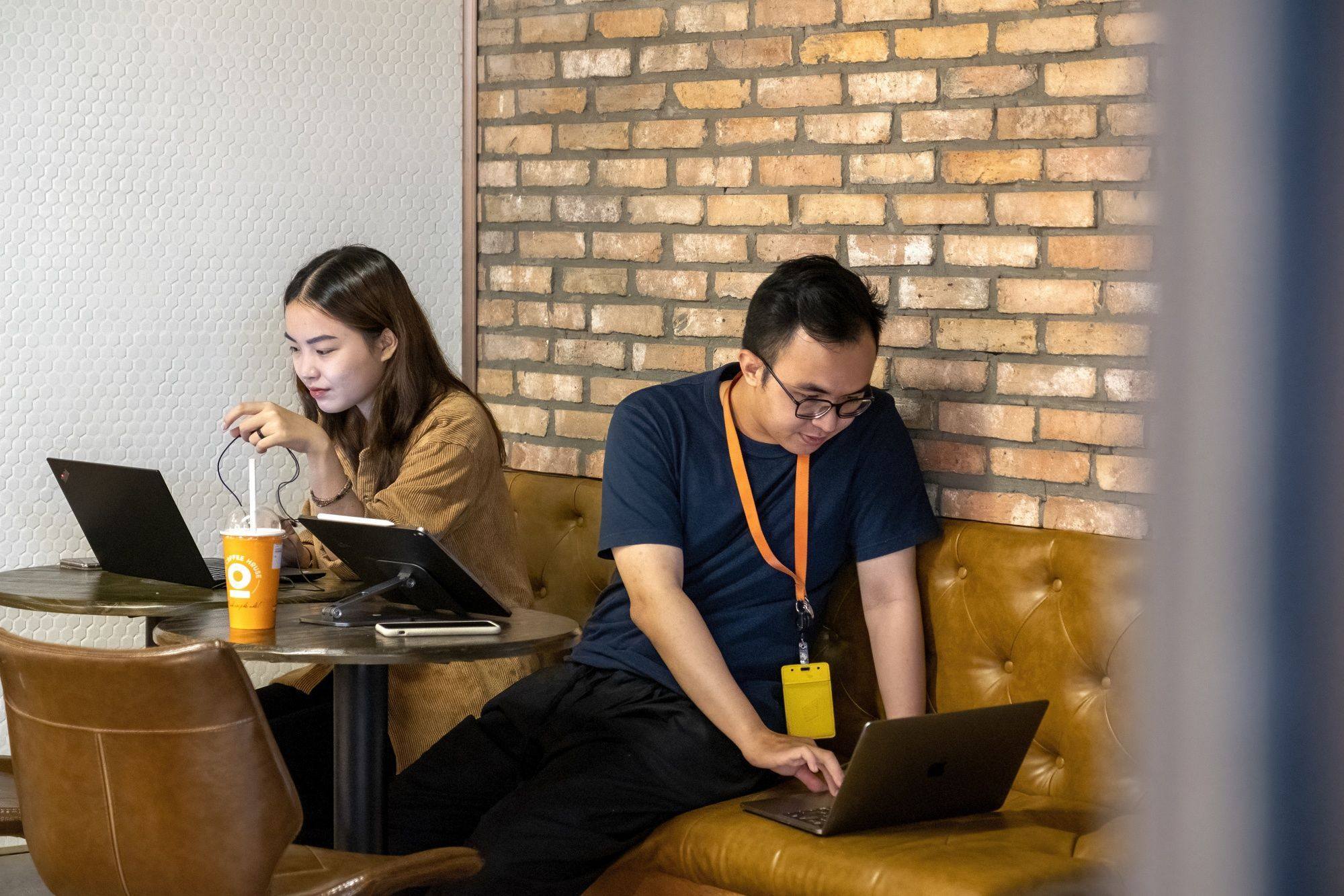 People use their laptops in an internet cafe in Ho Chi Minh City, Vietnam. Photo: Bloomberg