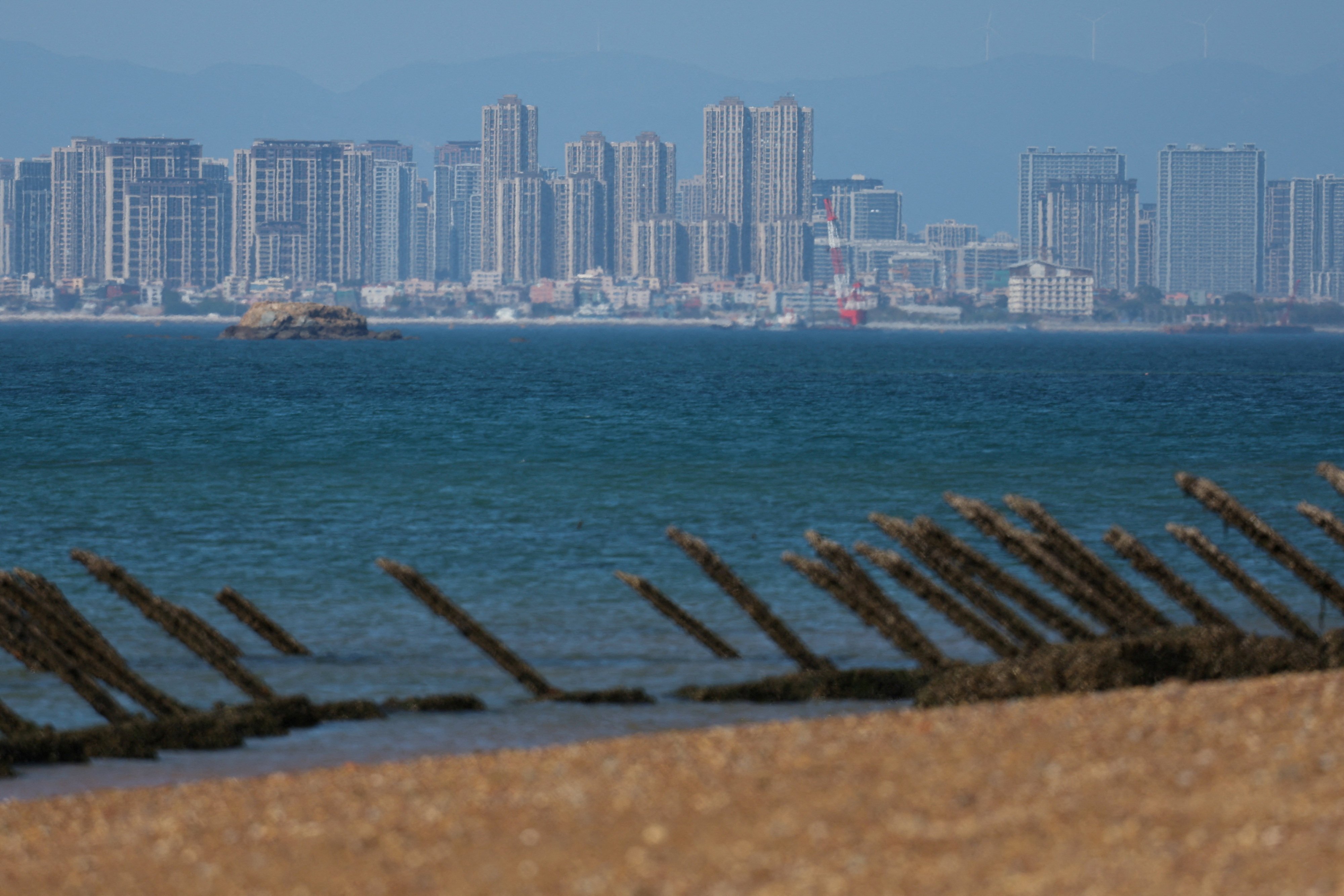 Anti-landing barricades on the beach at Taiwanese-controlled Quemoy Island, with the Chinese mainland in the background. Photo: Reuters