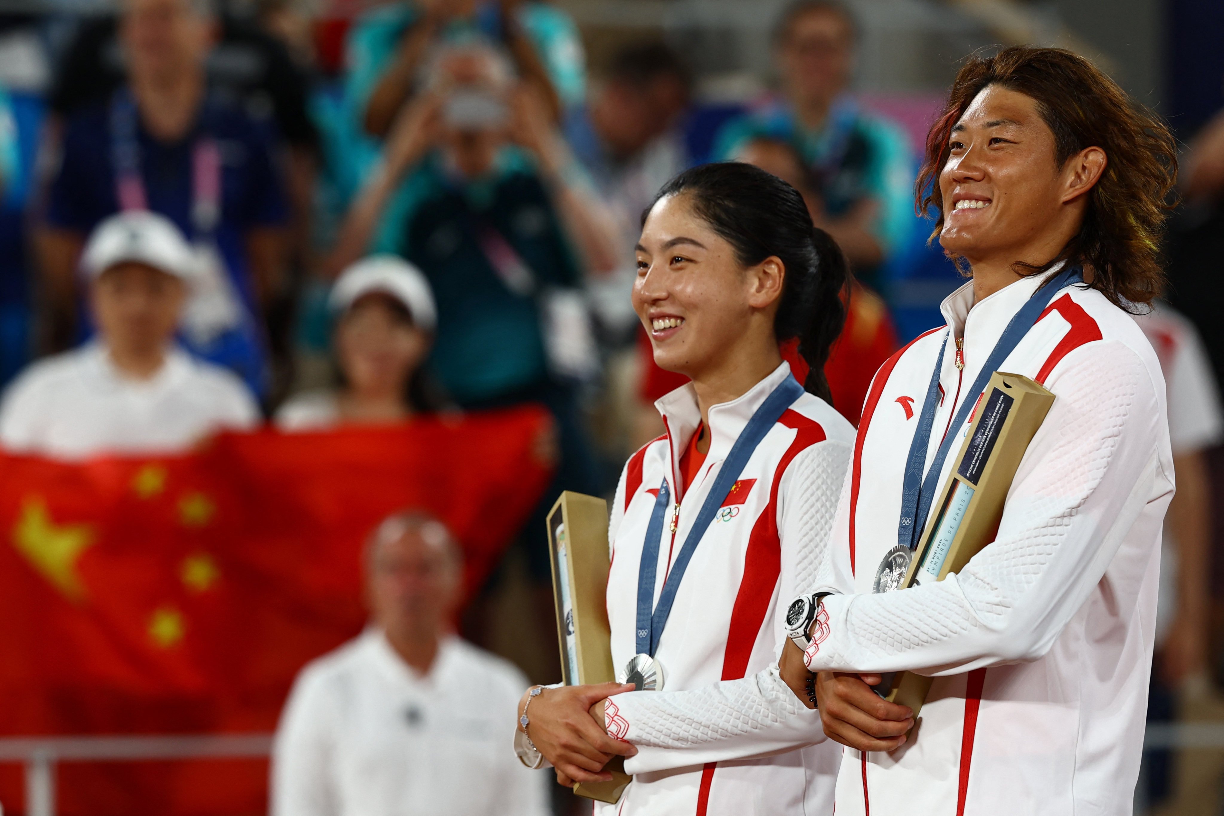 China’s Wang Xinyu, with doubles partner Zhang Zhizhen, on the Olympic podium in Paris. Photo: Reuters