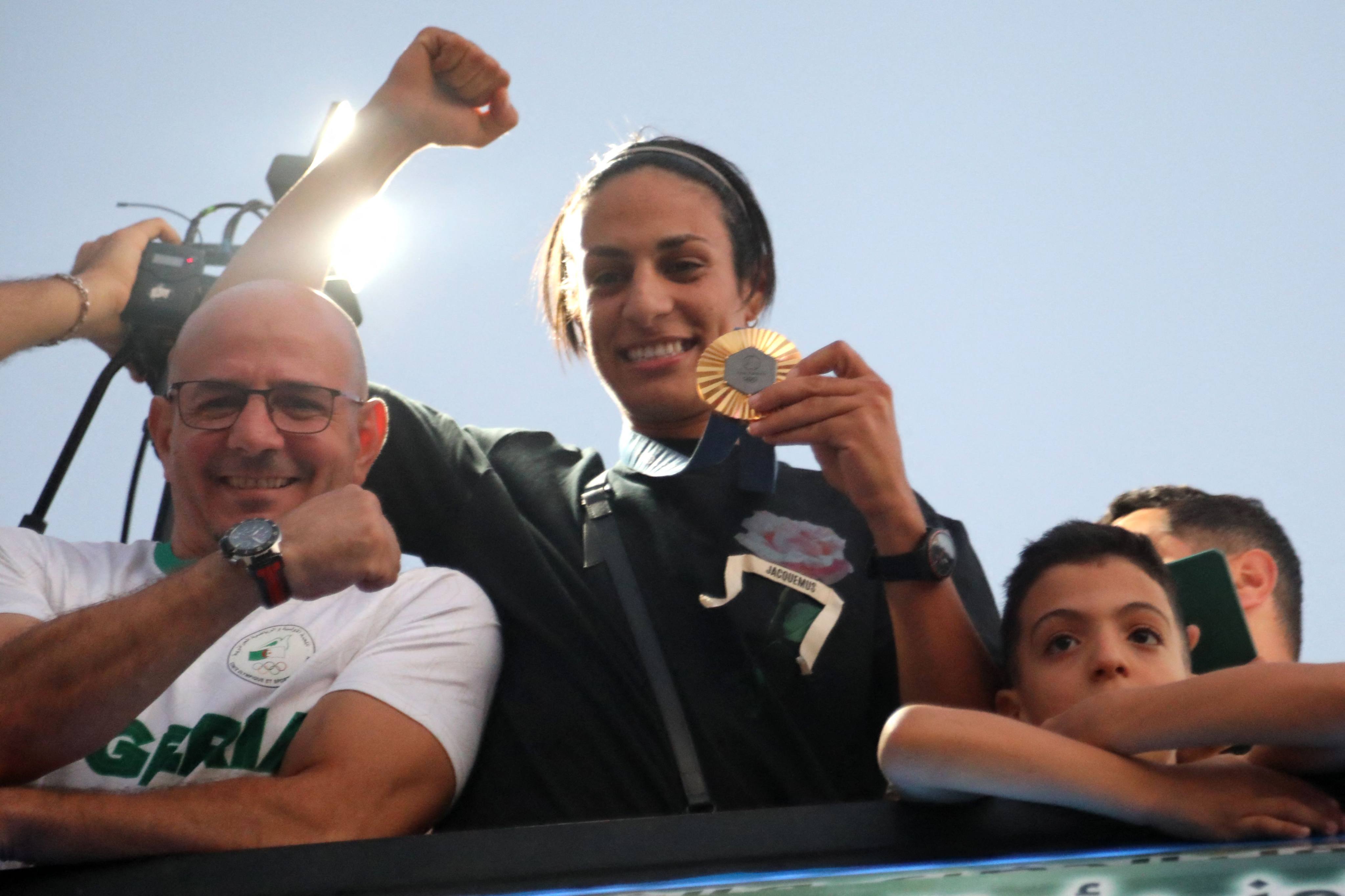 Algerian gold medallist Imane Khelif greets crowds during a bus tour in her hometown city of Tiaret. Photo: AFP