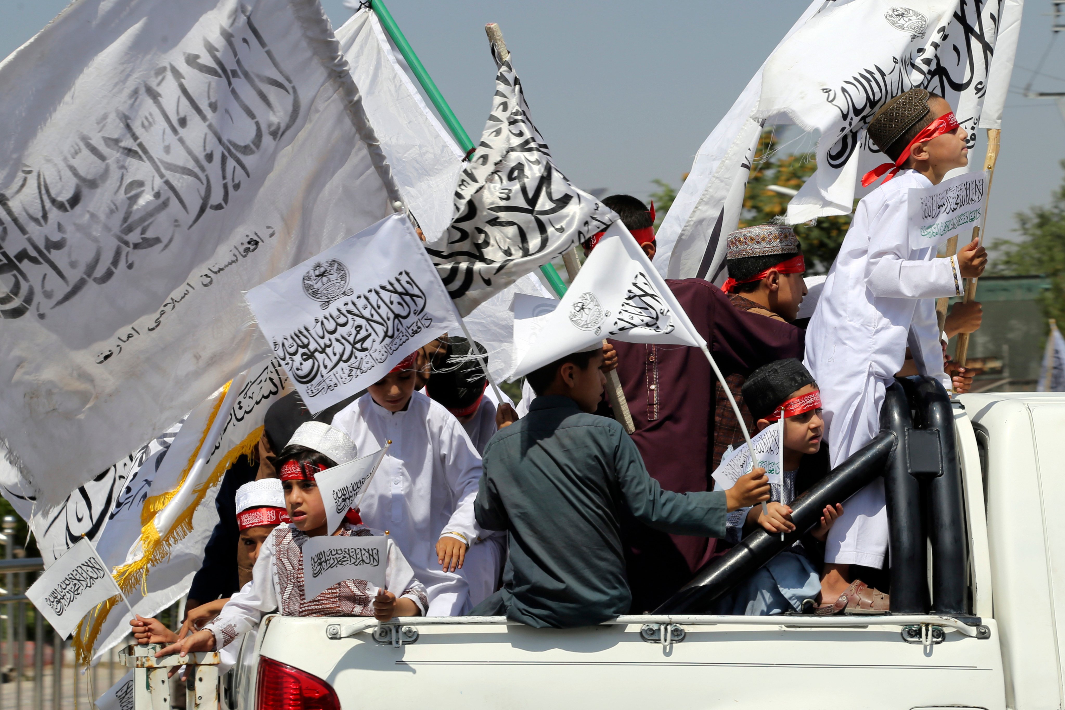 Children of Taliban fighters hold Taliban flags as they celebrate the third anniversary of the withdrawal of US-led troops from Afghanistan, in Kabul, Afghanistan, on Wednesday, August 14, 2024. Photo: AP