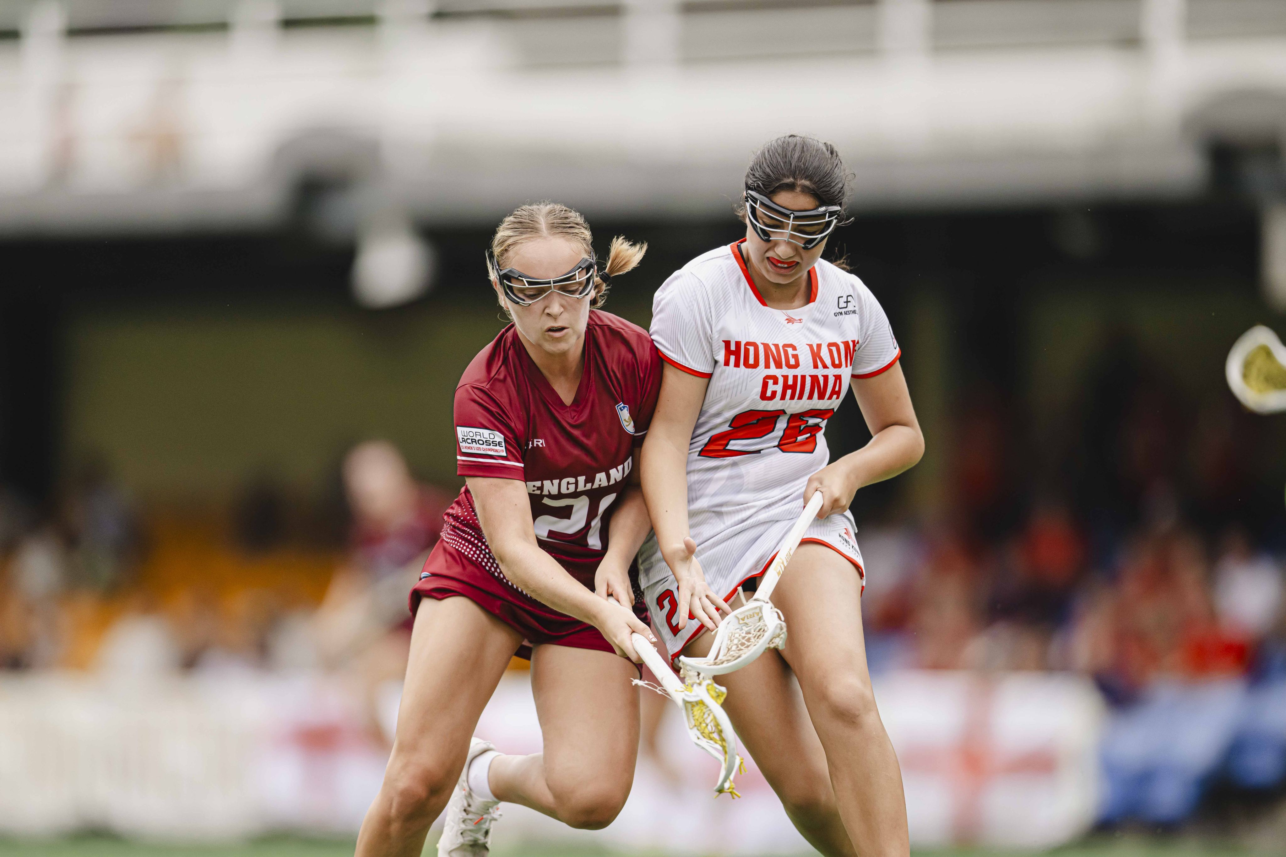 Hong Kong’s Ada Kurumlu (right) vies with Rachael Ball of England at Hong Kong Football Club. Photo: HKLAX