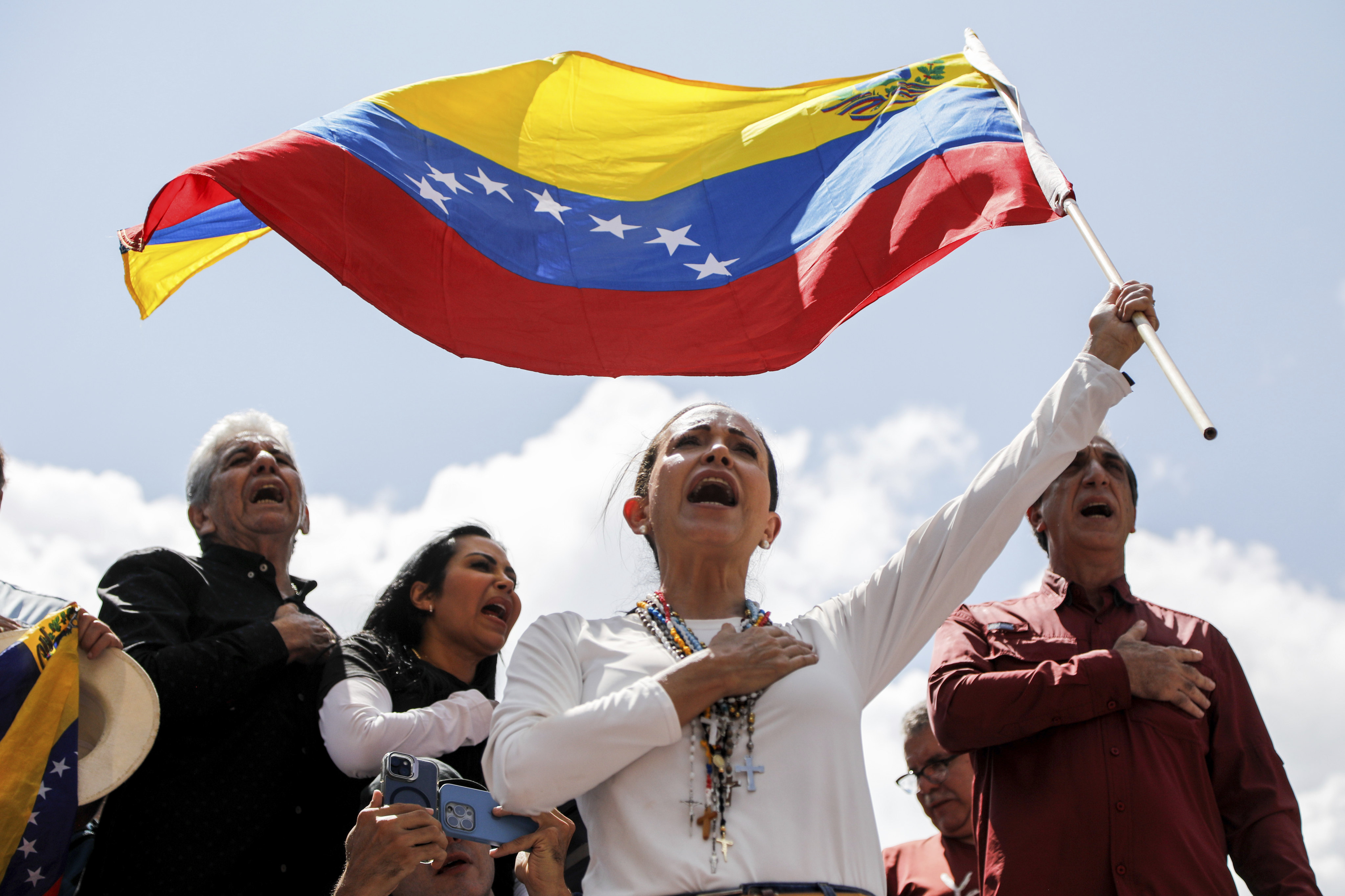 Opposition leader Maria Corina Machado waves a Venezuelan flag during a rally in Caracas, Venezuela, on Saturday. Photo: AP