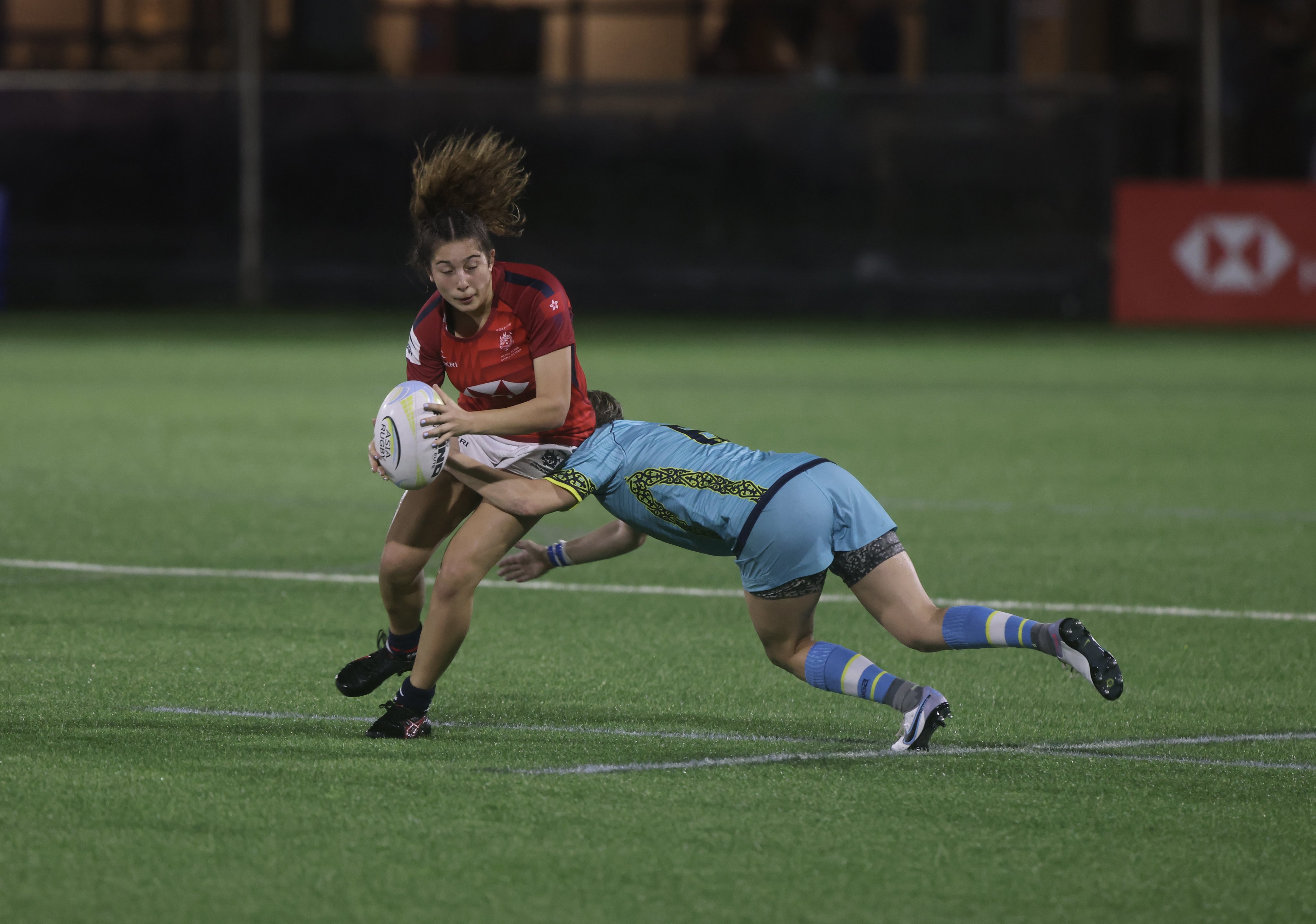 Hong Kong fly-half Georgia Rivers (left) is tackled by Kazhakstan’s Mariya Grishina during their Asia Rugby Championship game in June. Photo: Jonathan Wong