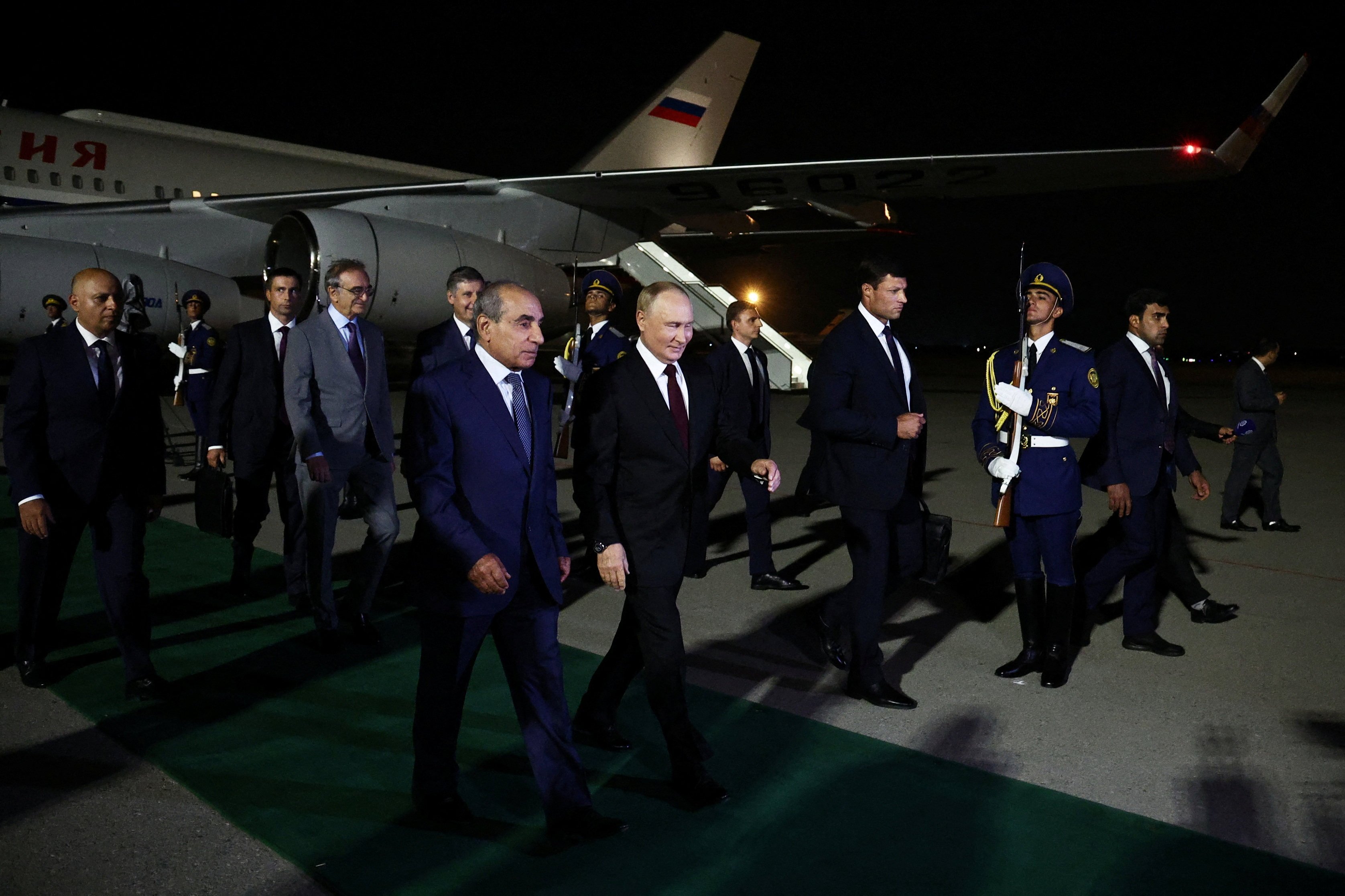 Russian President Vladimir Putin (centre) is welcomed upon arrival at the airport in Baku, Azerbaijan on Sunday. Photo: Sputnik via Reuters