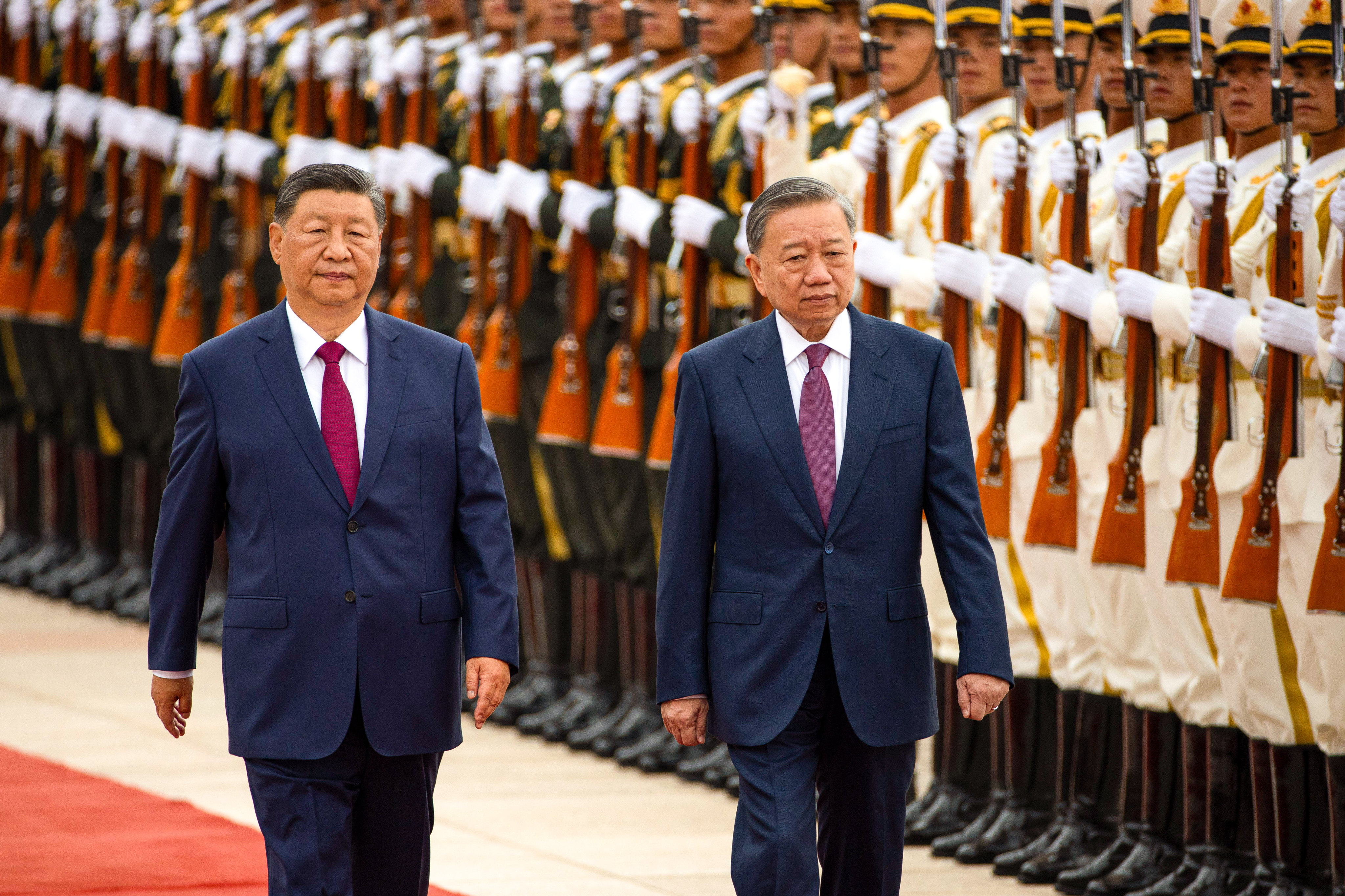 Chinese President Xi Jinping (left) and Vietnamese President To Lam inspect an honour guard as they make their way to the  Great Hall of the People in Beijing on Monday.  Photo: EPA-EFE