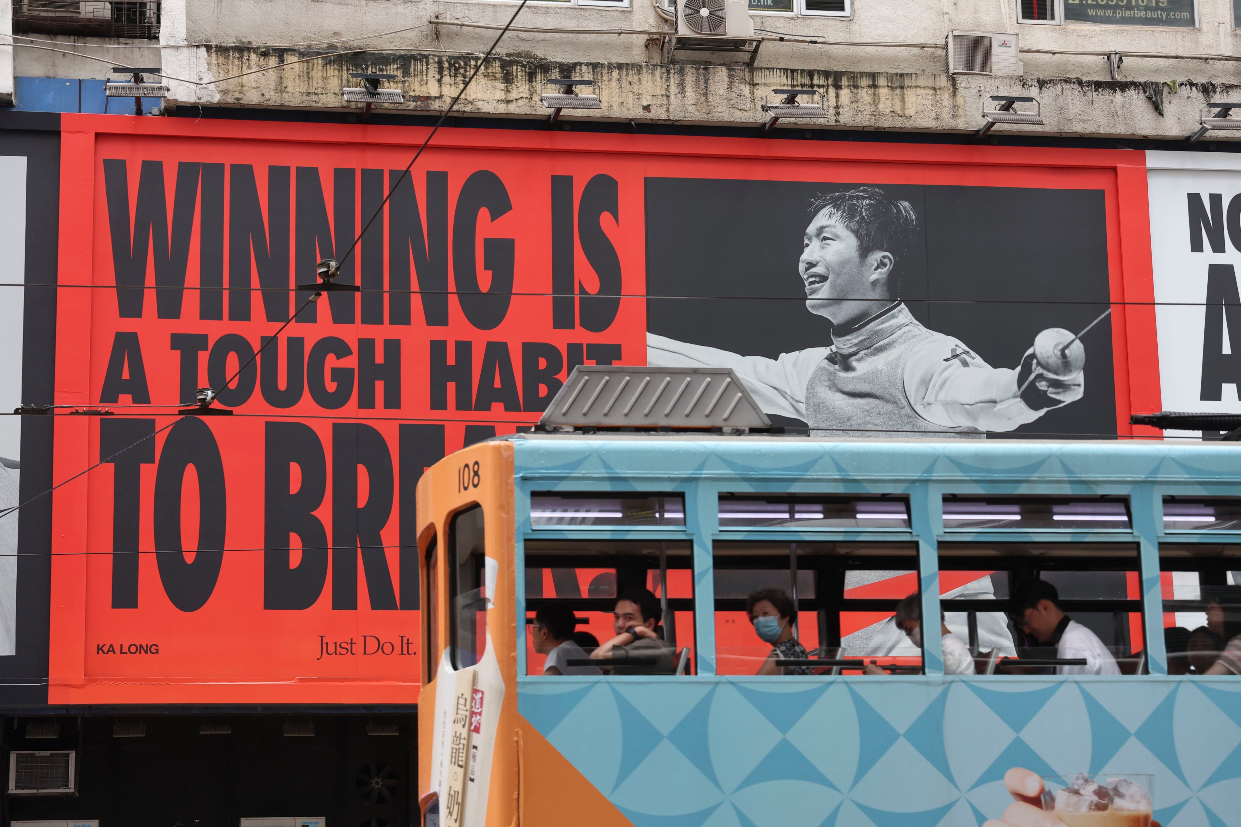 A tram passes an advertisement featuring Hong Kong fencer and Olympic gold medalist Cheung Ka-long in Causeway Bay on August 17. Photo: Dickson Lee