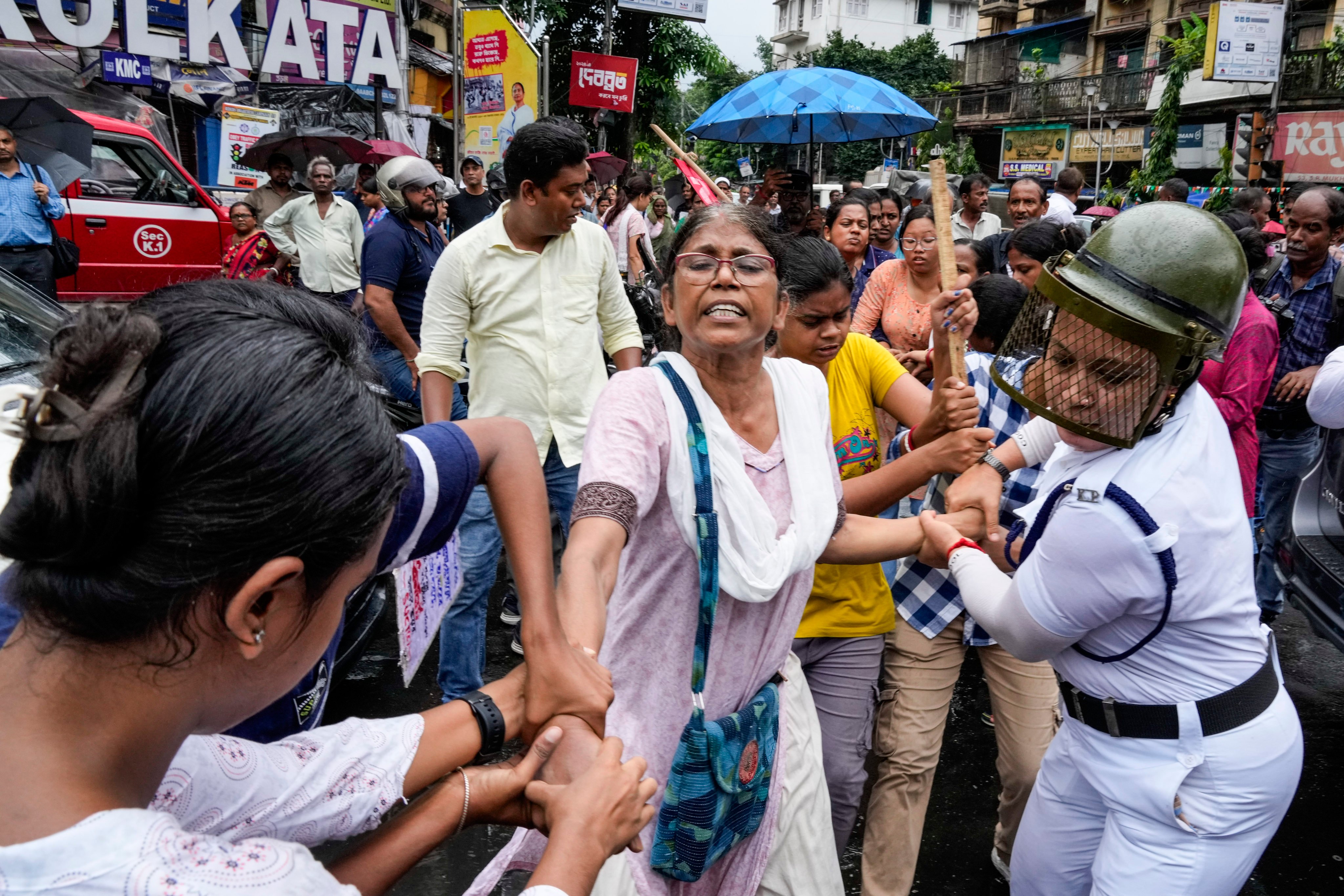 Police detain an activist in Kolkata on Friday during a protest rally following the rape and killing of a trainee doctor in a government hospital. Photo: AP