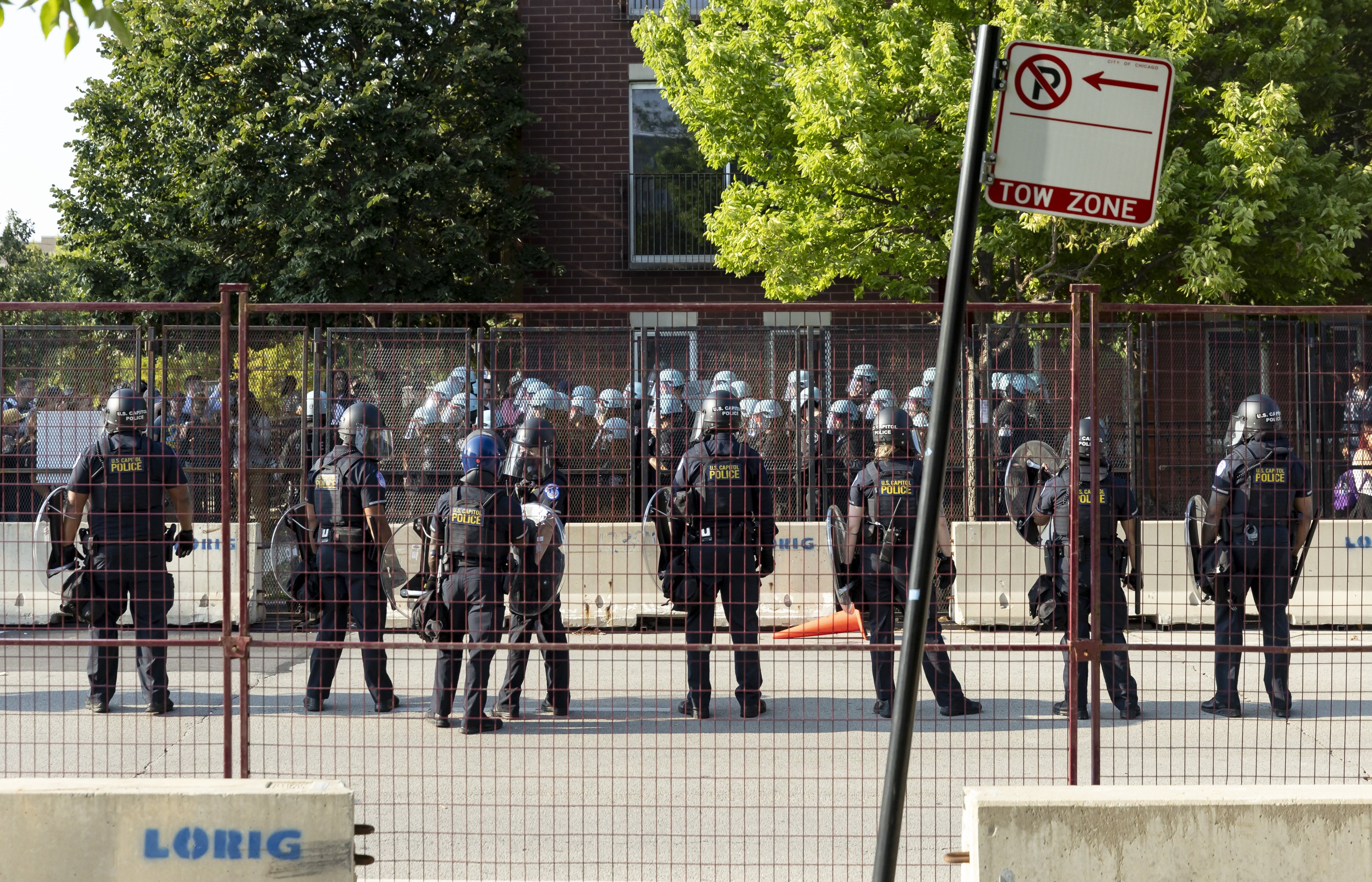 Police in riot gear confront protesters breaking through the perimeter fencing on the opening night of the Democratic National Convention (DNC) at the United Centre in Chicago, Illinois on Monday. Photo: EPA-EFE