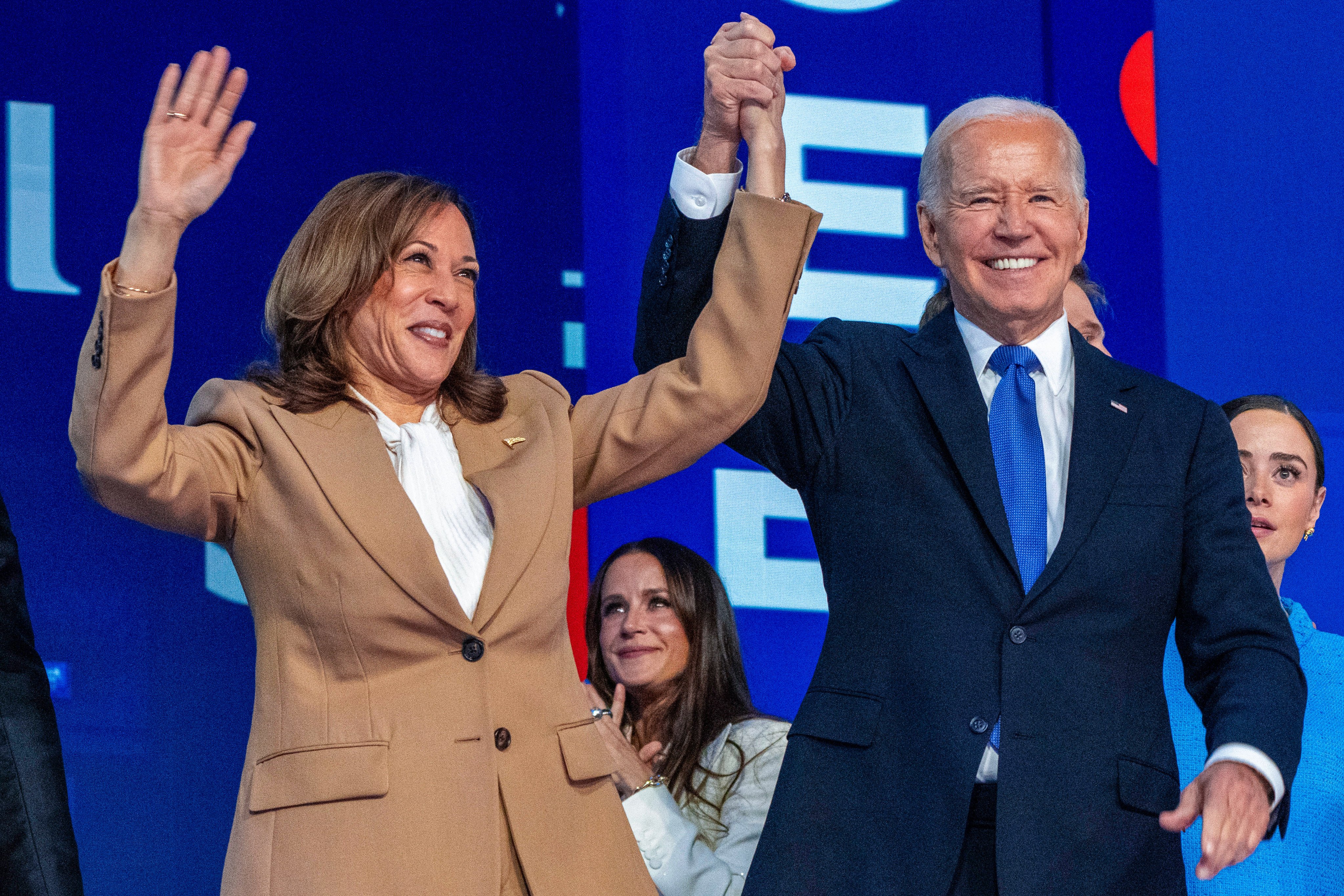 Democratic presidential nominee Vice-President Kamala Harris clasps hands with US President Joe Biden at the Democratic National Convention on Monday in Chicago. Photo: AP