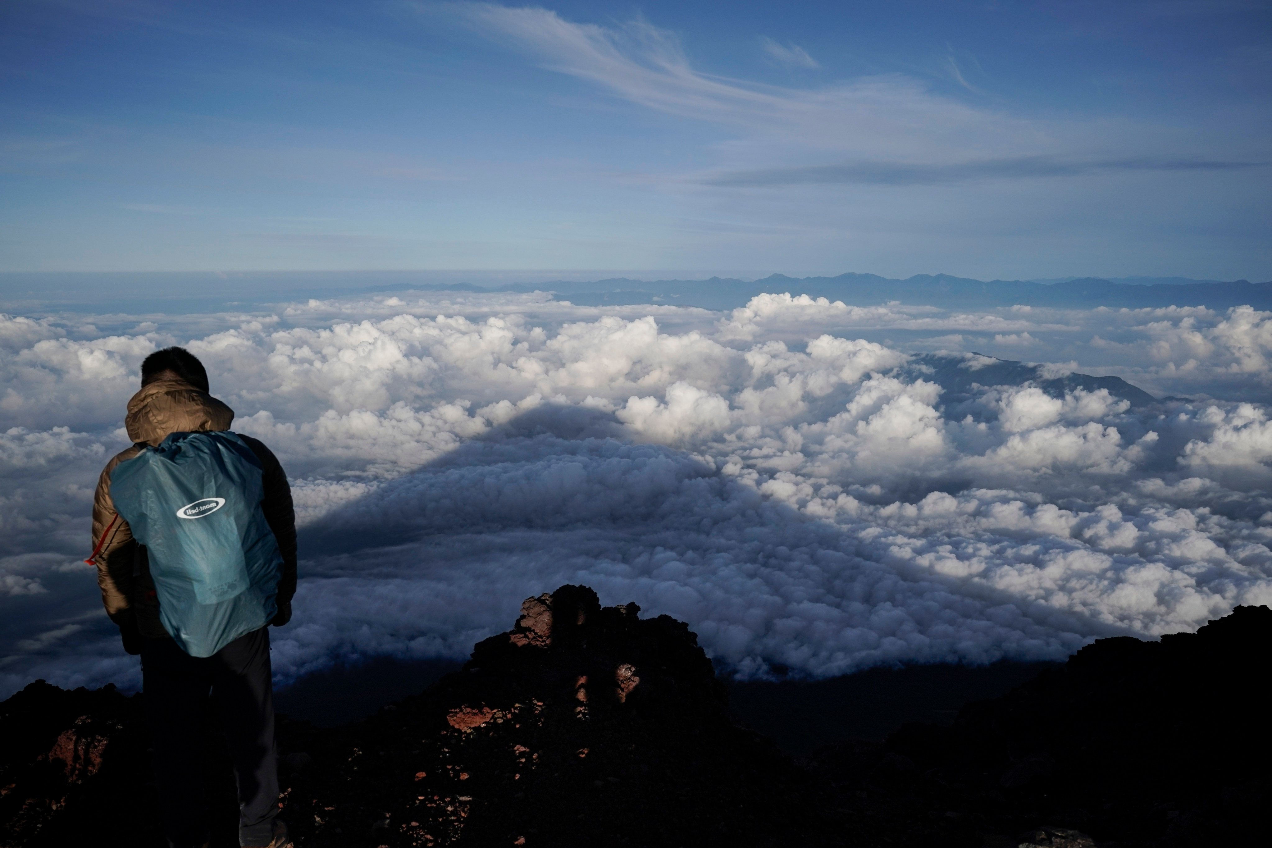 The shadow of Japan’s Mount Fuji is cast on clouds hanging below the summit. Photo: AP