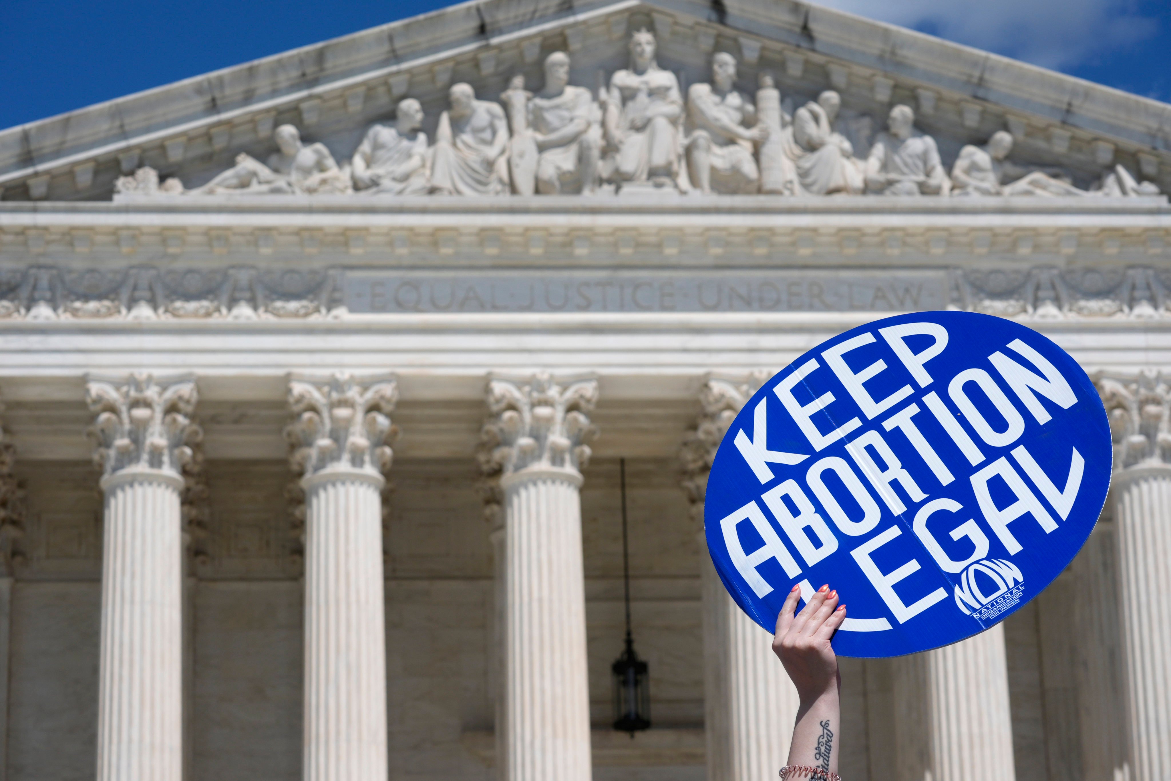 A demonstrator in Washington holds a placard during a protest in support of reproductive rights and emergency abortion care on June 24. Photo: Reuters