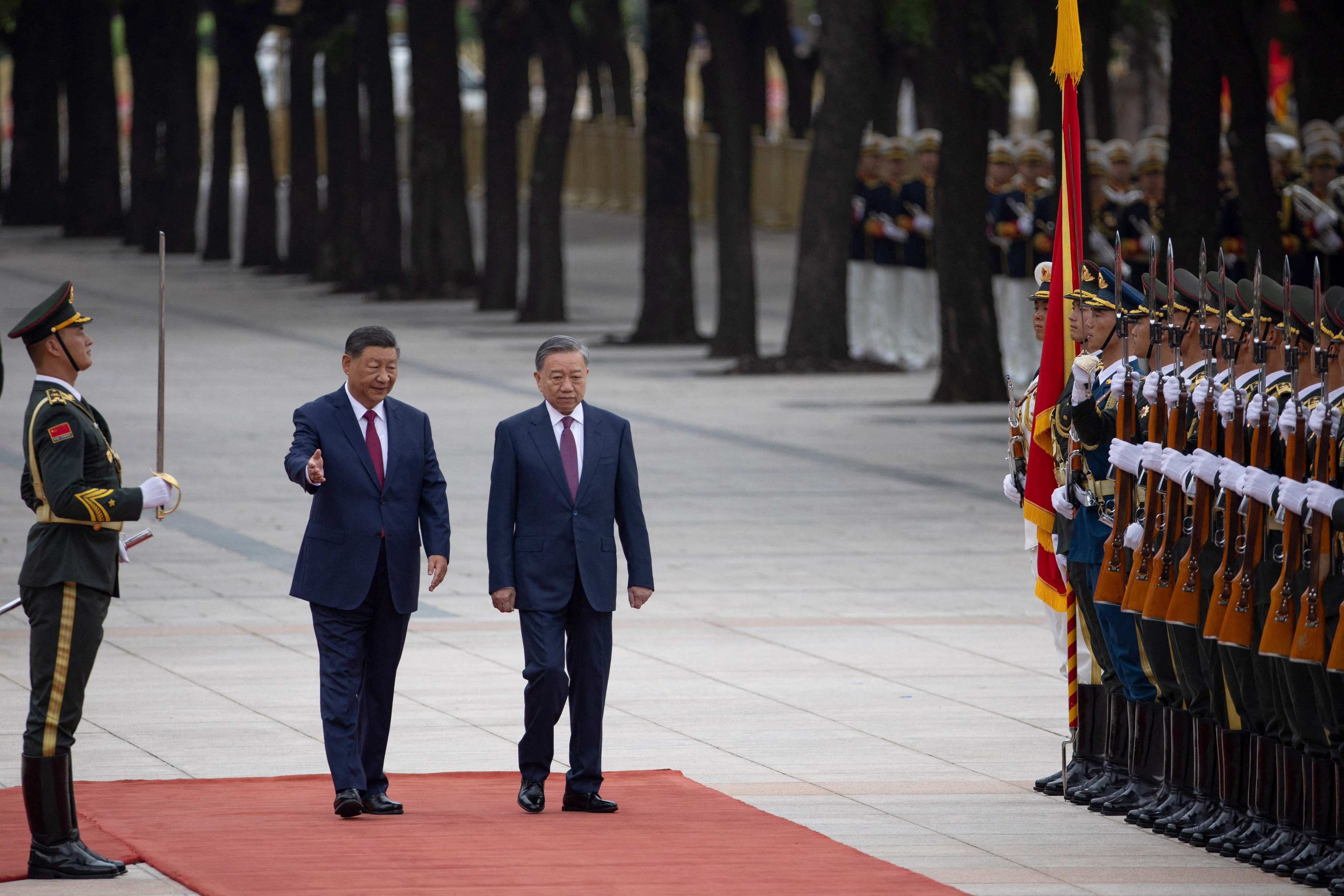 Chinese President Xi Jinping (left) walks next to Vietnam President To Lam as they pass by the honour guard during a welcome ceremony at the Great Hall of the People in Beijing on August 19. Photo: AFP