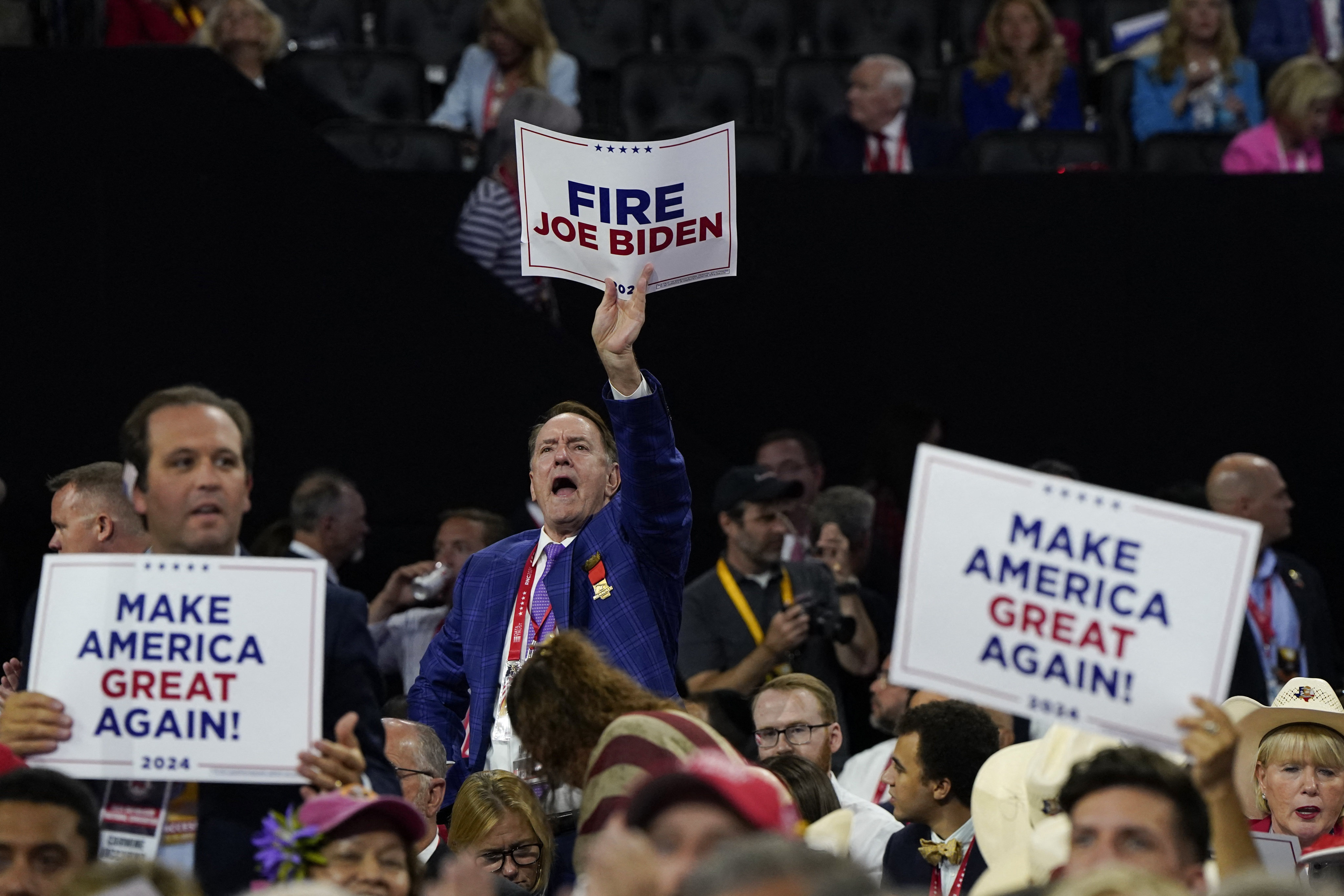 An attendee holds a Fire Joe Biden sign on Day 4 of the Republican National Convention (RNC) in Wisconsin, U.S on July 18, 2024. Photo: Reuters