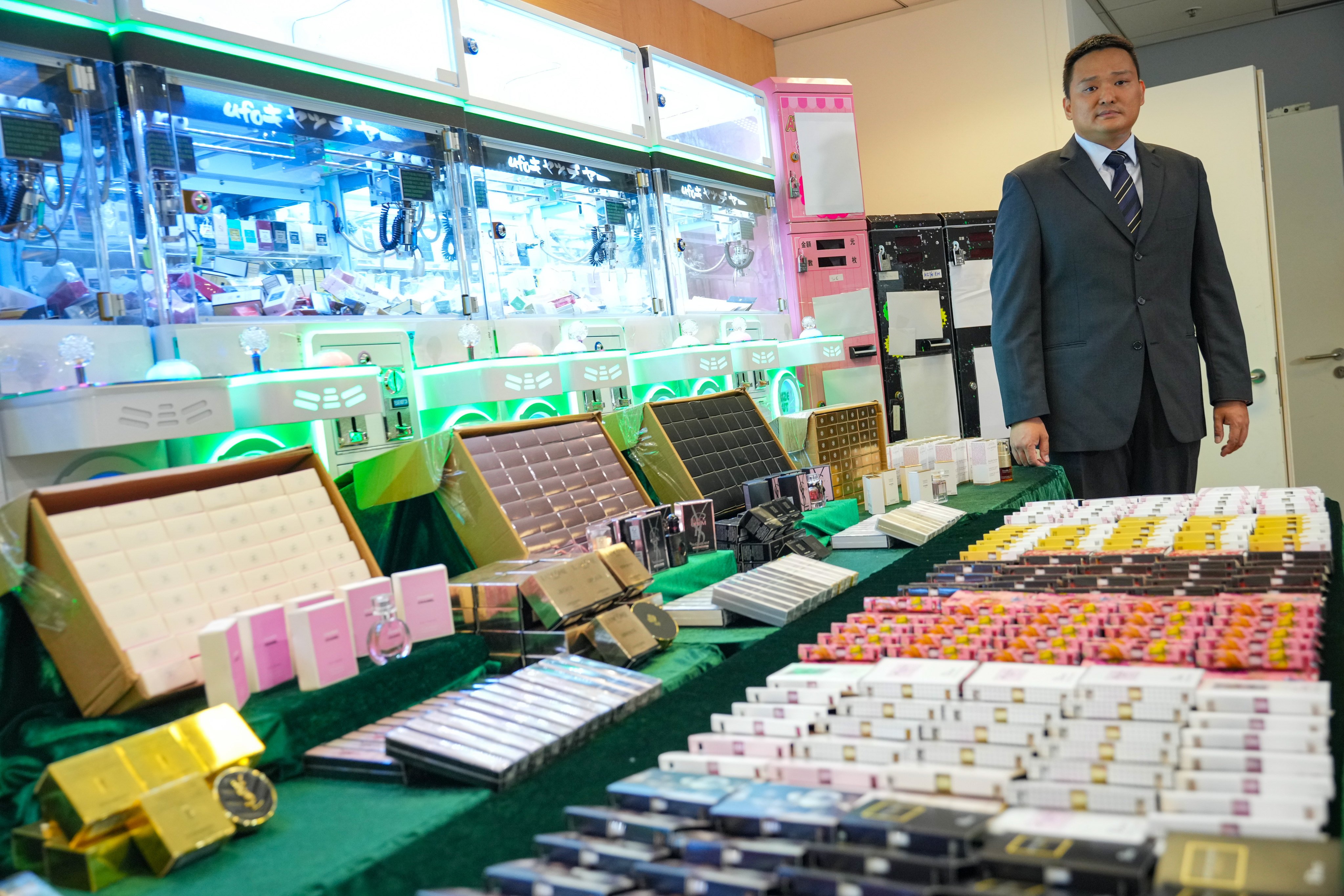 Senior Inspector Chau Hoi-man of customs’ intellectual property investigation bureau says it is first time his department has discovered claw machine stores offering fake brand-name perfumes. Photo: May Tse