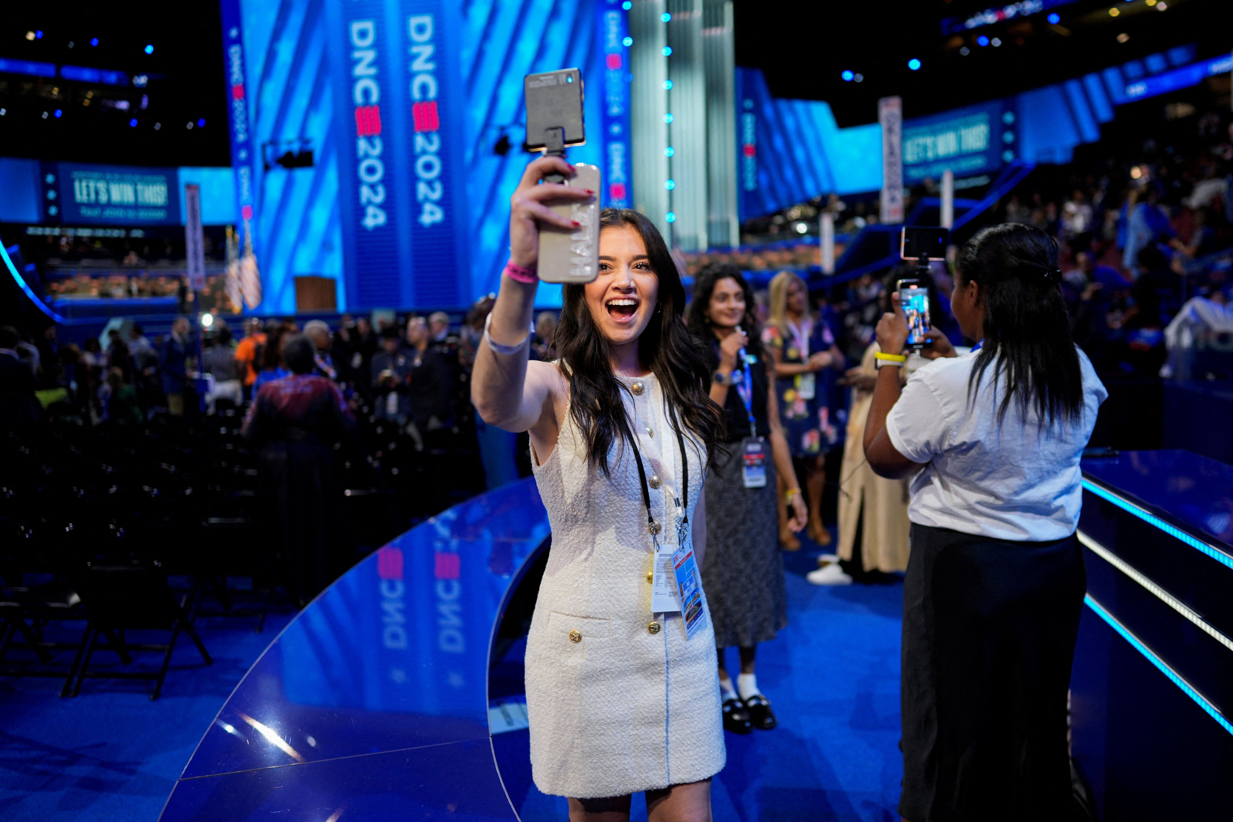 A social media influencer uses a phone during the Democratic National Convention. Photo: Reuters