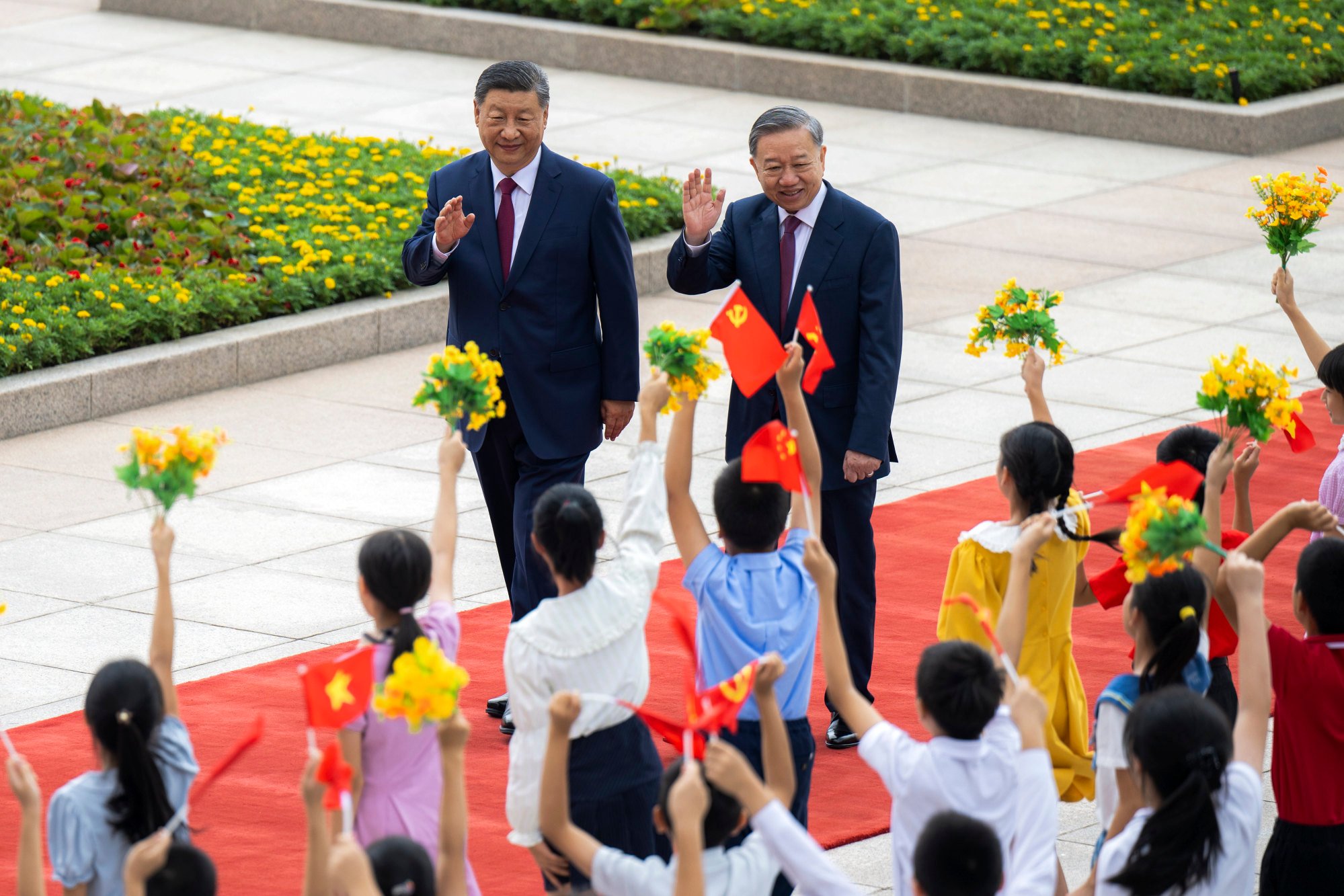 Vietnamese leader To Lam (right) is cheered by children at a welcome ceremony held by Chinese President Xi Jinping at the Great Hall of the People in Beijing on Monday. Photo: Xinhua via AP