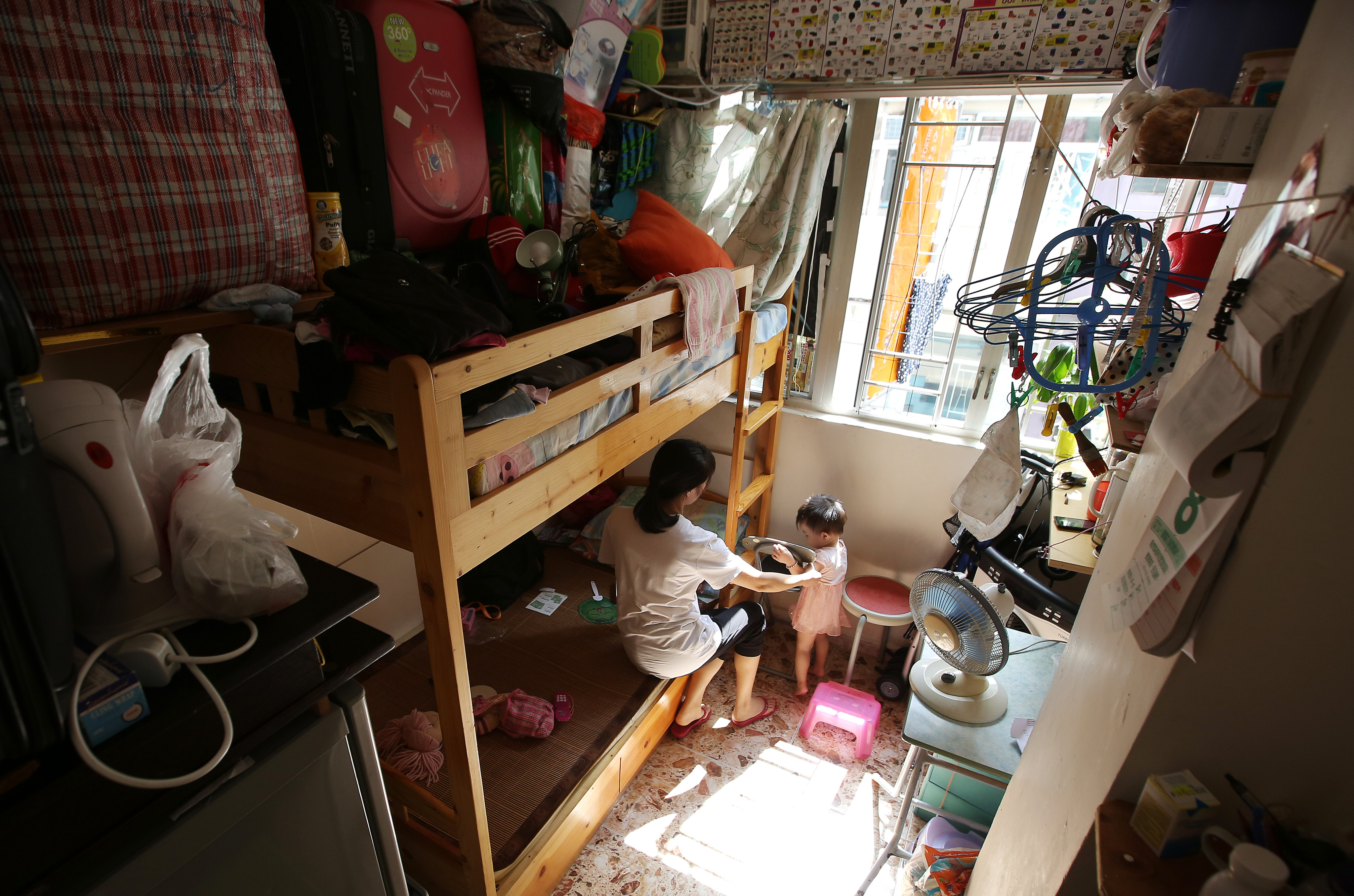 A woman and her chid in a subdivided flat in Sham Shui Po in October 2016. Photo: Edward Wong