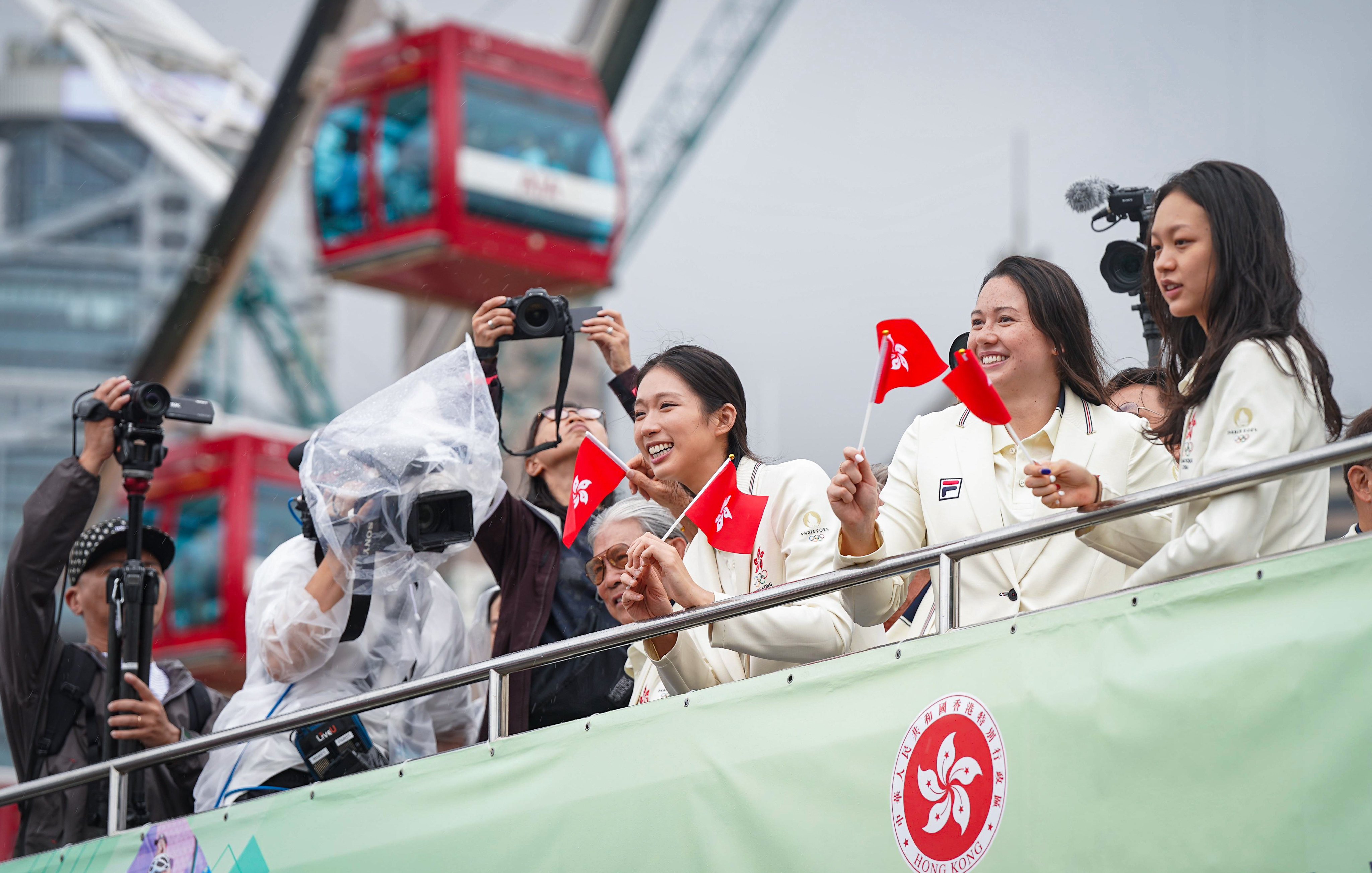 Smiles all round as the Hong Kong athletes fly the city’s flag in Central. Photo: Elson Li