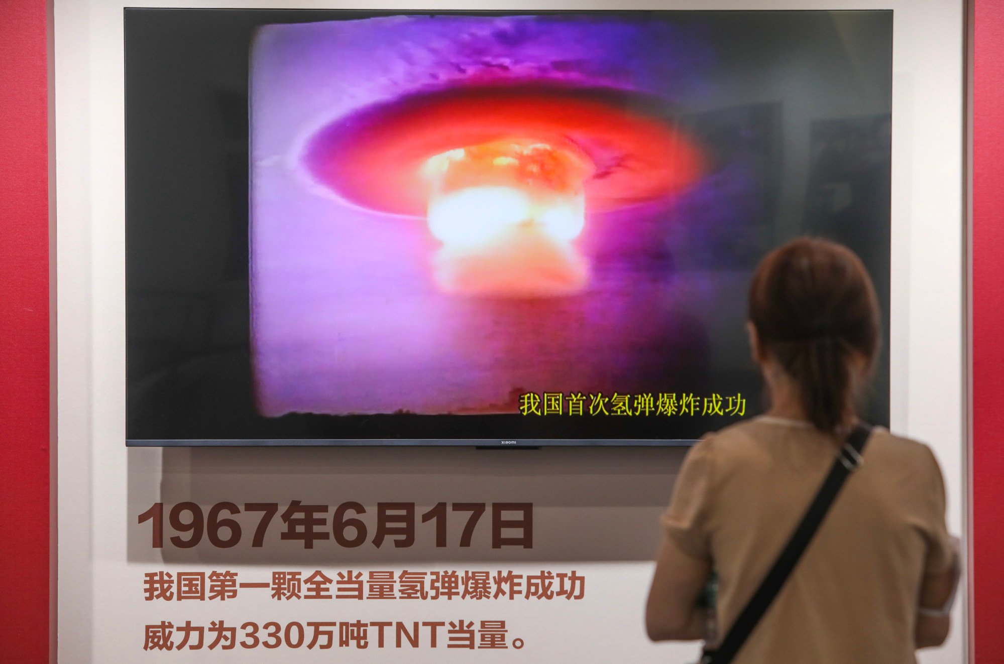 A visitor watches a film clip of China’s first successful hydrogen bomb test, in 1967, at an exhibition at the China Scientists Museum in Beijing in June. Photo: Simon Song/SCMP