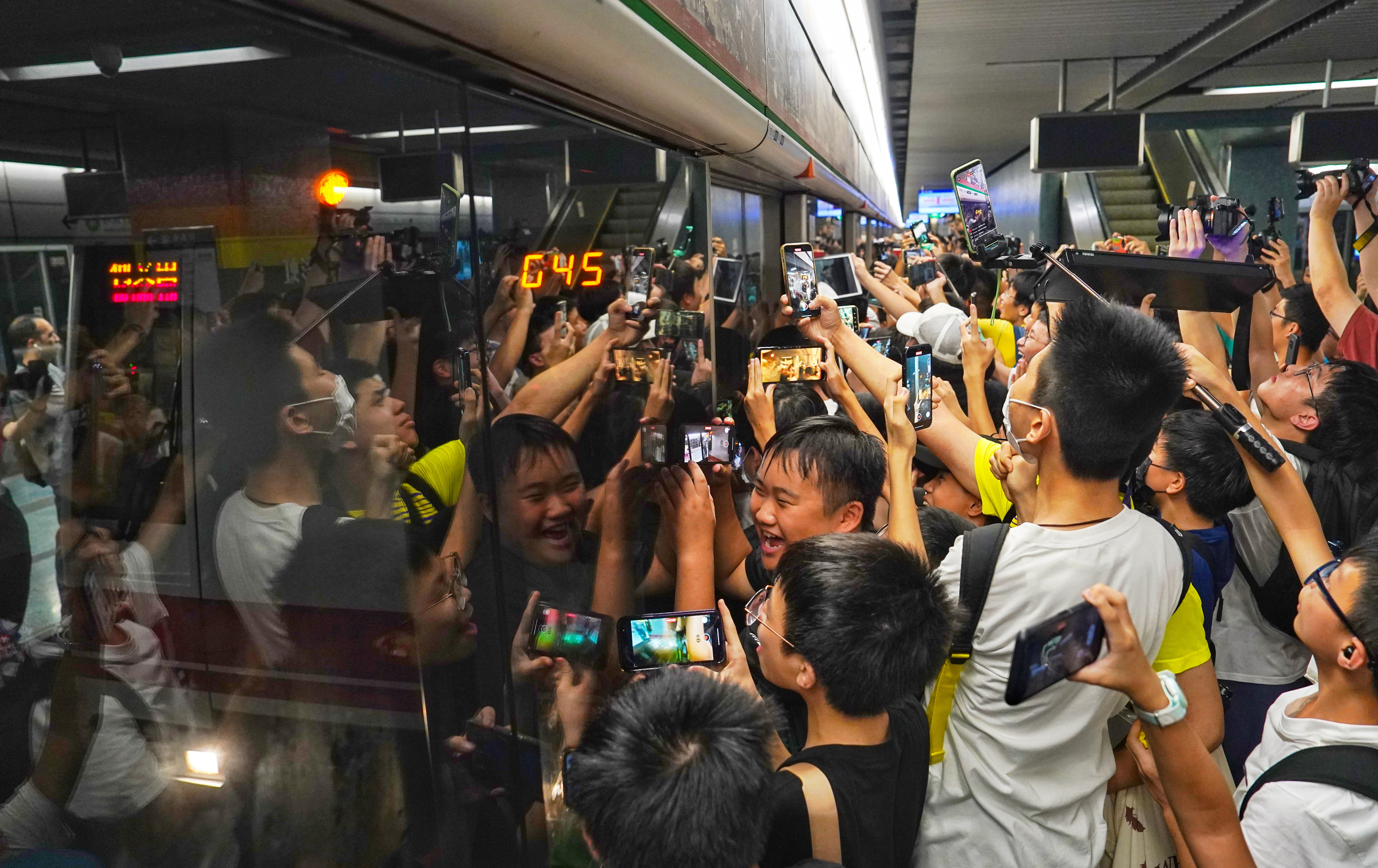 Fans crowd the platform in a bid to get onto the themed train for its first trip. Photo: Elson Li