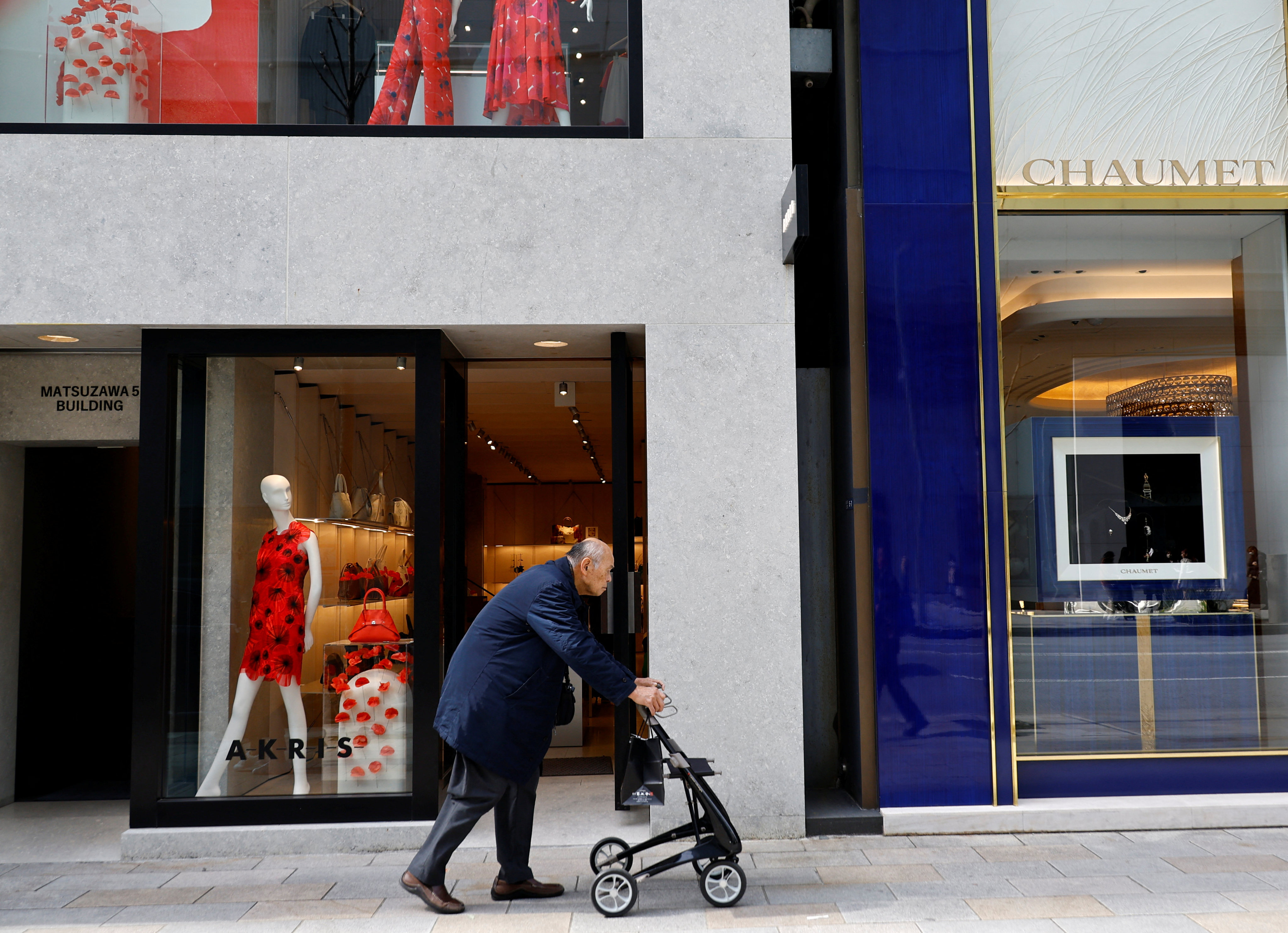 A man makes his way through a shopping district in Tokyo, on March 19. Japan is grappling with a rapidly declining population and escalating social security costs. Photo: Reuters