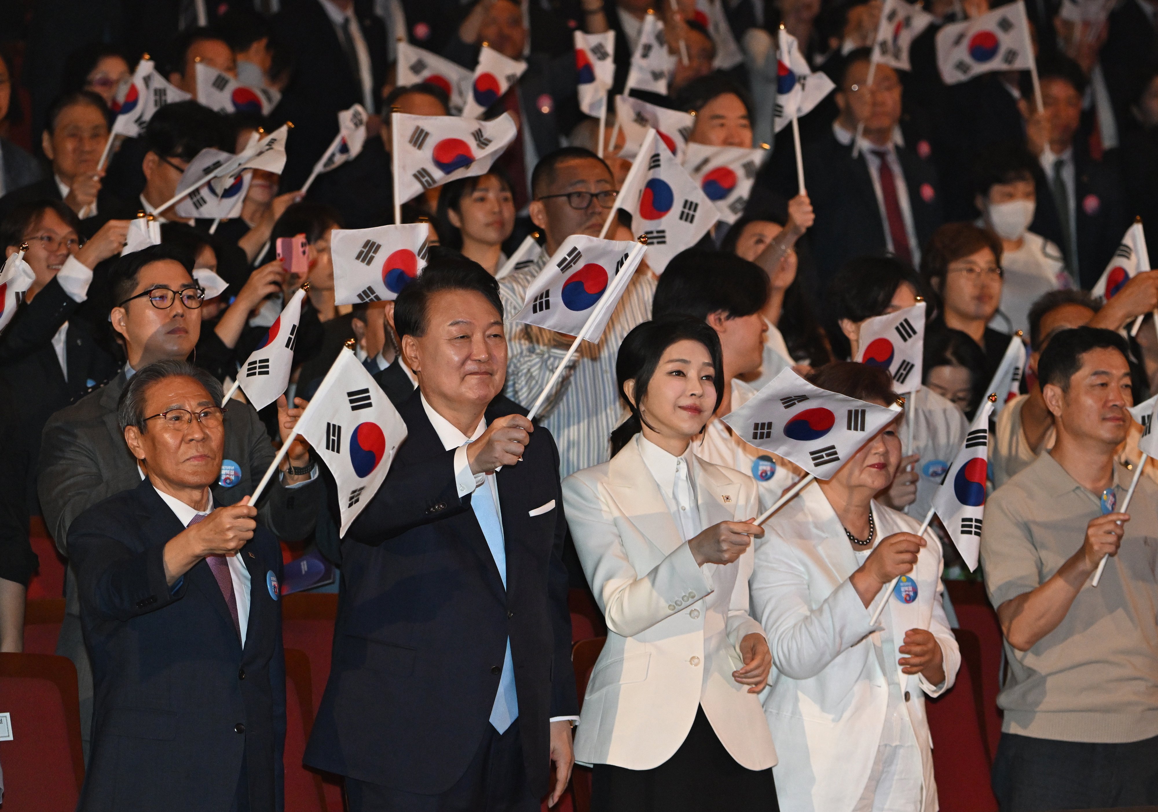 South Korean President Yoon Suk-yeol and his wife Kim Keon-hee wave national flags during the celebration of the 79th National Liberation Day in Seoul on August 15. Photo: EPA-EFE