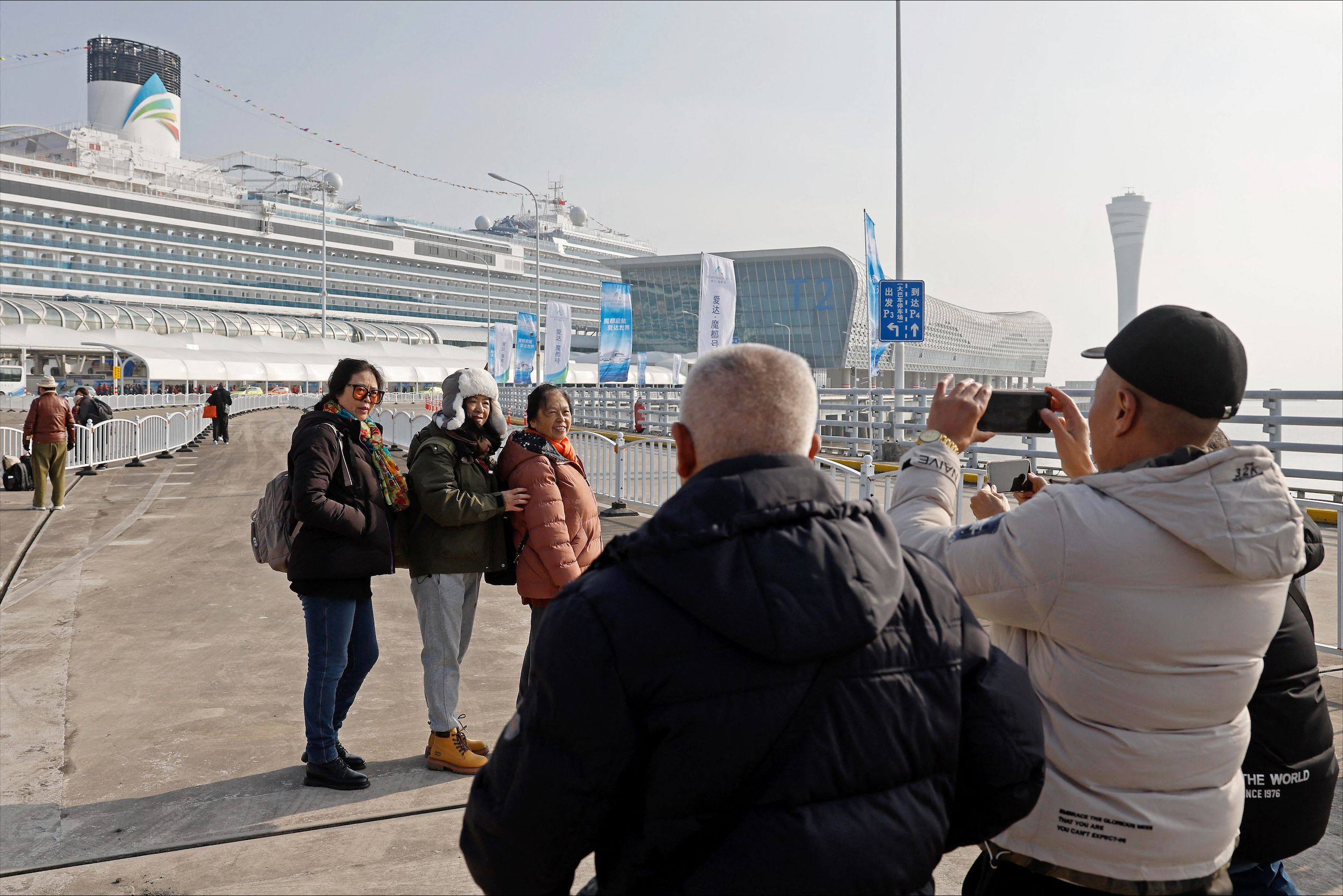 Passengers take photos before boarding China’s first domestically built cruise ship, the Adora Magic City, in Shanghai in January. Photo: AFP