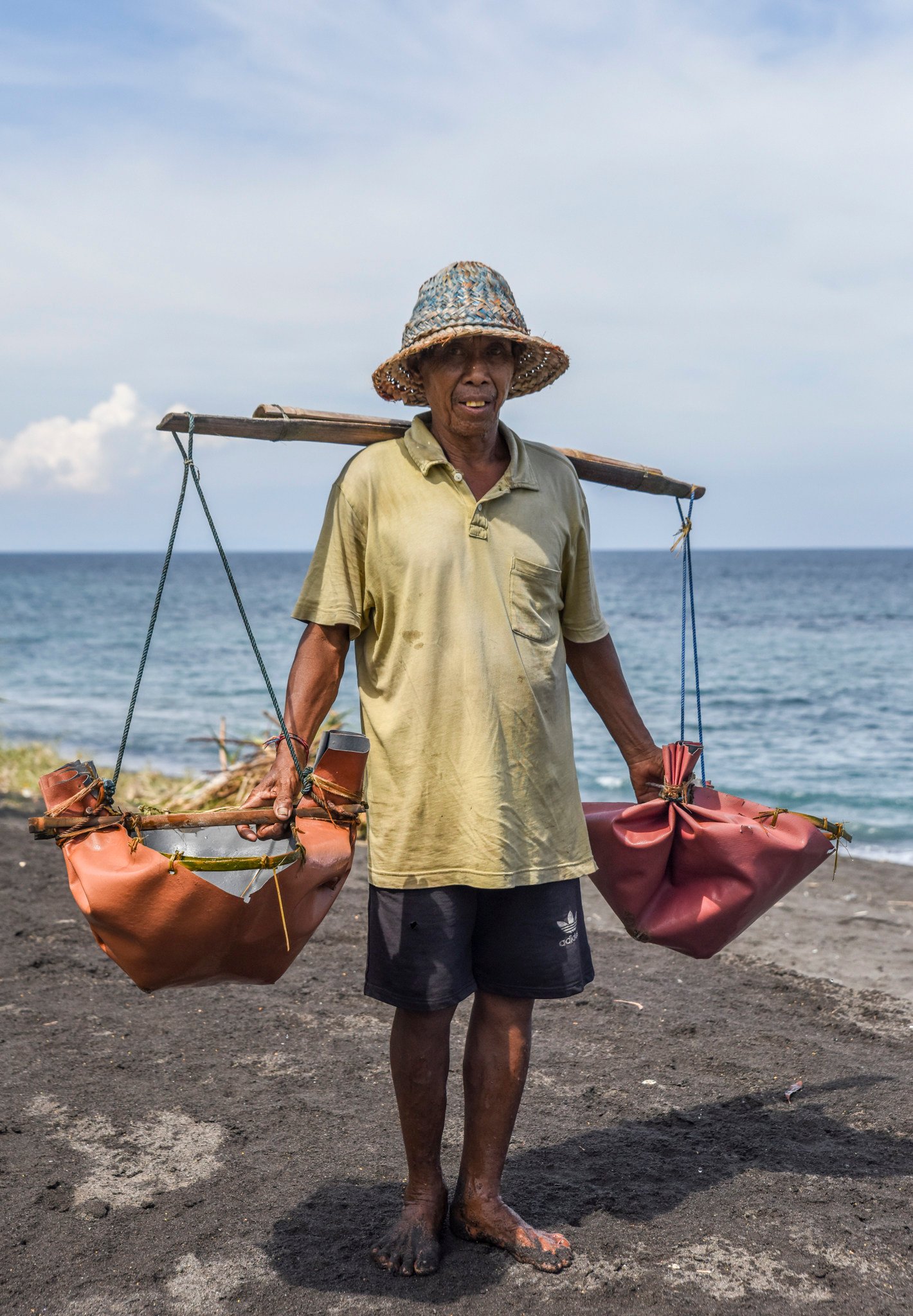 The salt farmers of Kusamba, Bali, bring salt water up the black-sand beach in palm-leaf buckets. Photo: Ronan O’Connell