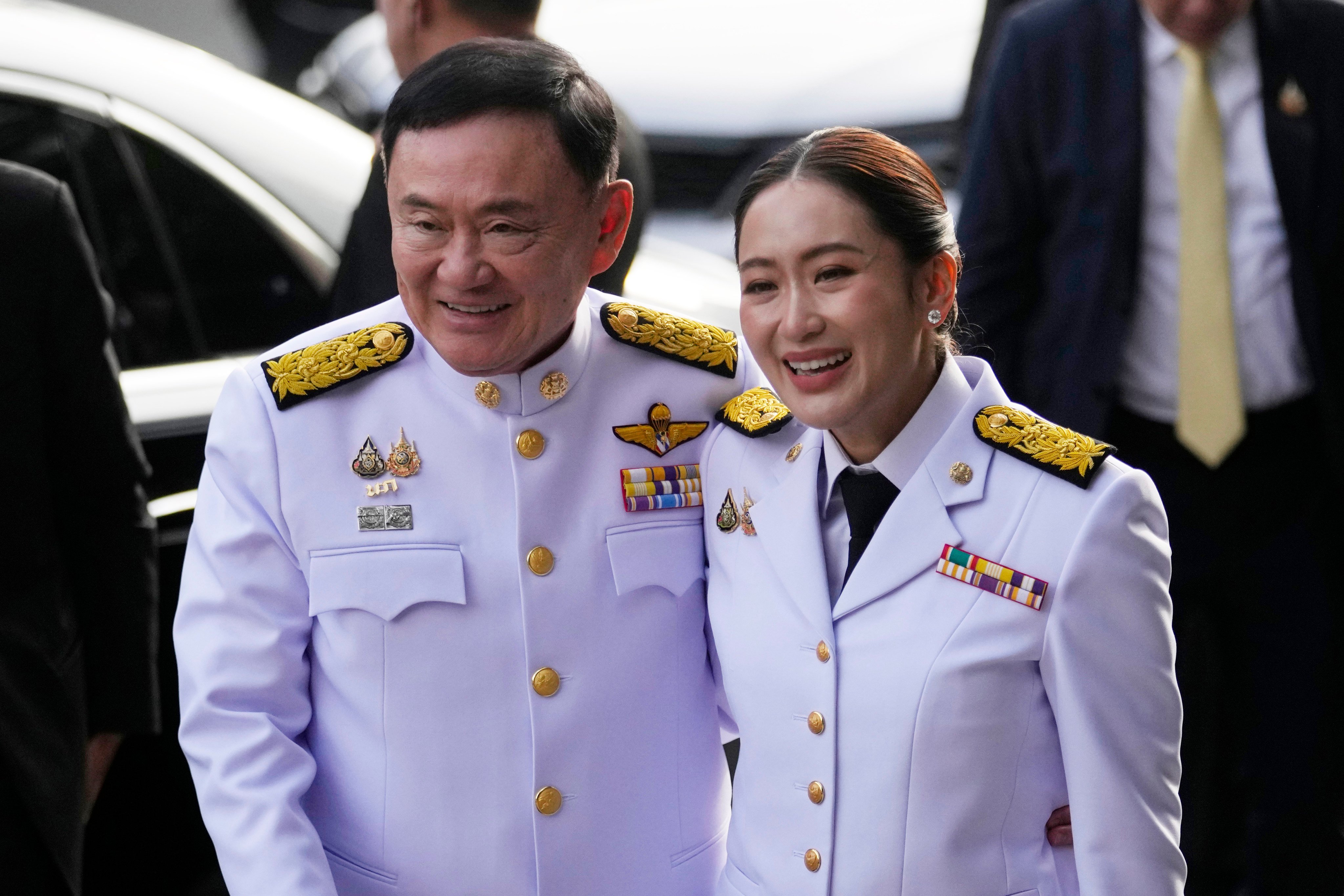 Thaksin Shinawatra and his daughter Paetongtarn arrive at Pheu Thai party headquarters in Bangkok before the royal endorsement ceremony appointing her as Thailand’s new prime minister on August 18. Photo: AP