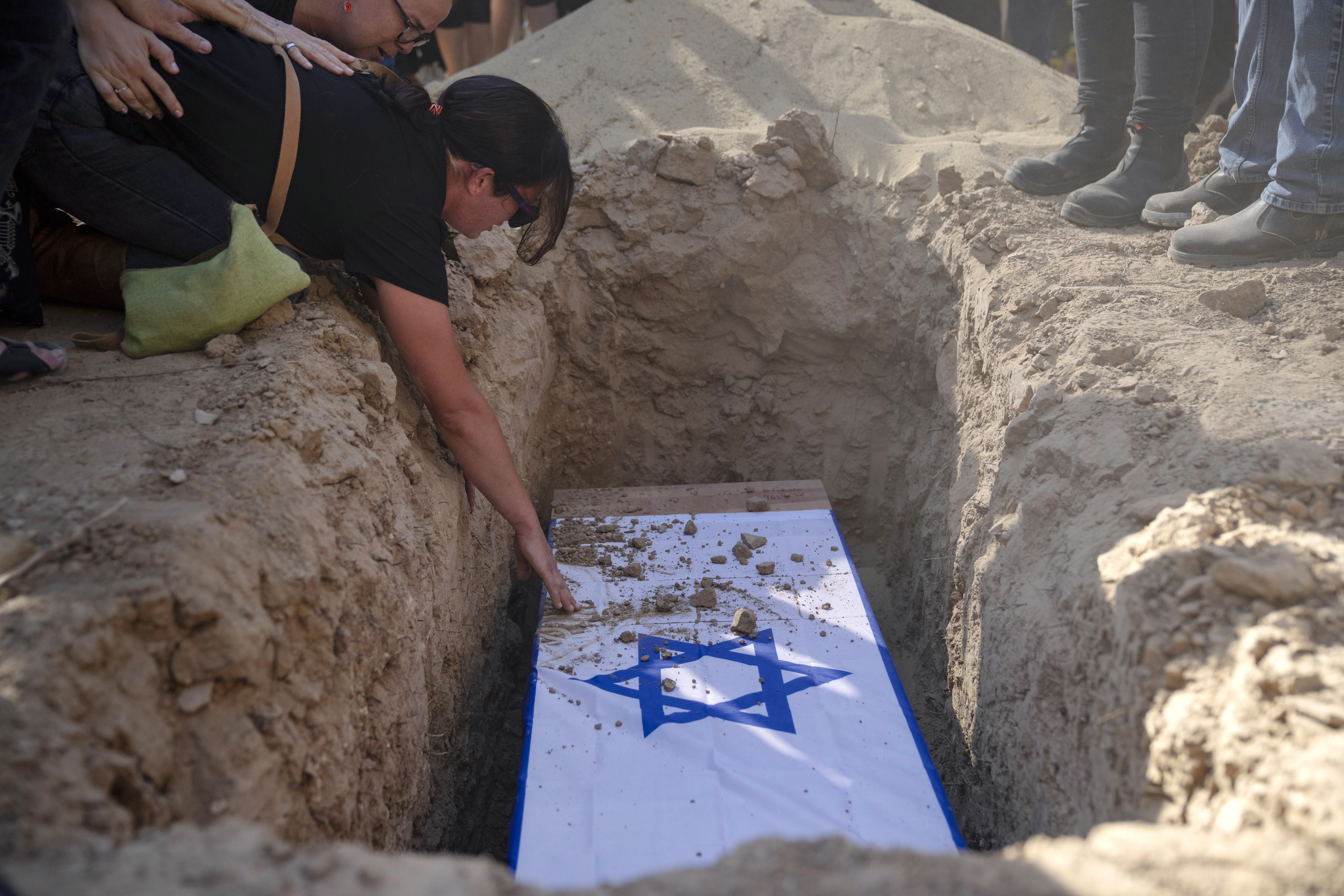 Rimon Buchshtab mourns during the funeral of her husband Yagev Buchshtab, who was found dead in Gaza, at the Kibbutz Nirim cemetery in Israel on Wednesday. Photo: AP