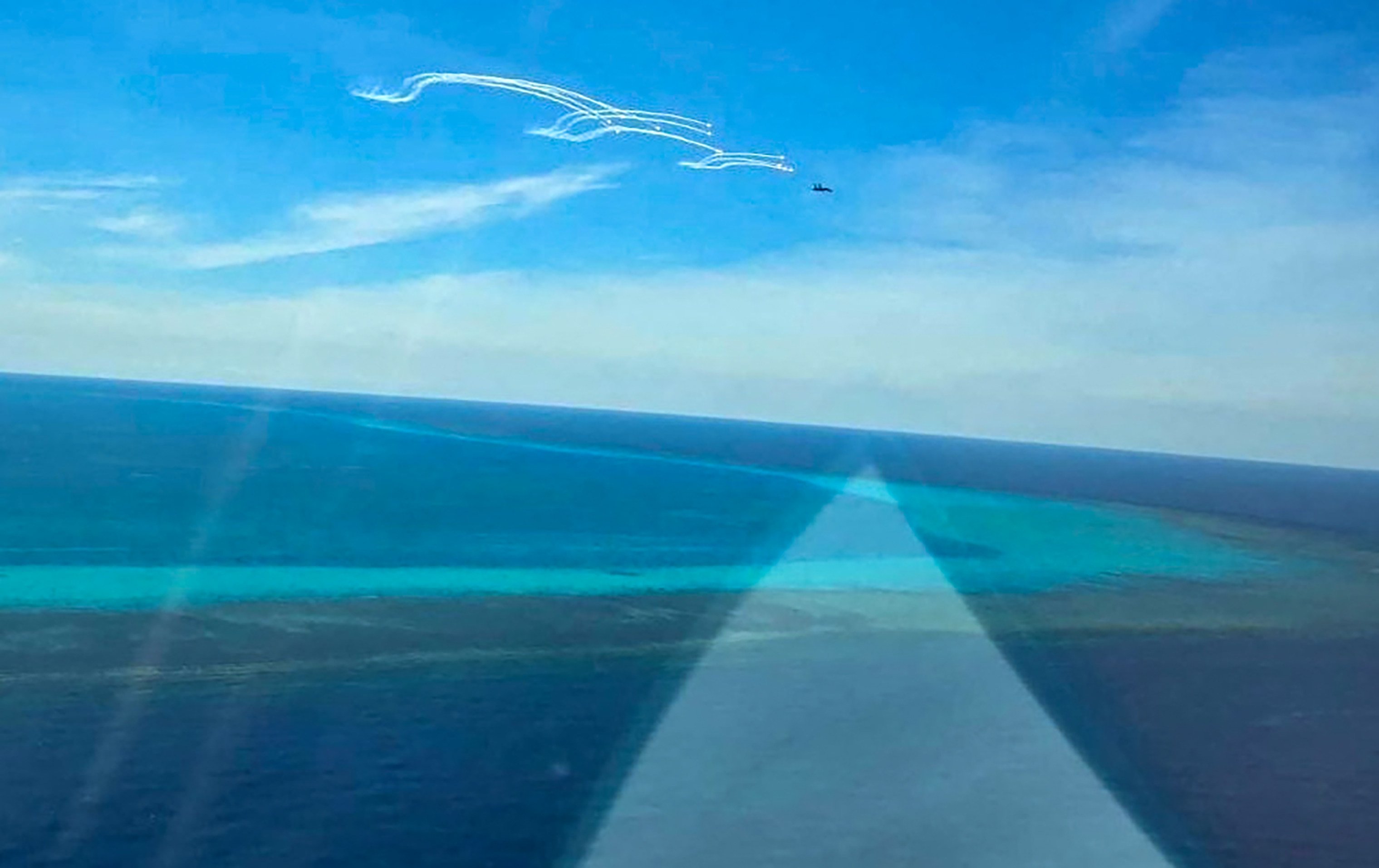 Manila says a Chinese fighter jet deployed flares near a Philippine fisheries bureau patrol plane near near Scarborough Shoal in the South China Sea. Photo: AFP / Philippine Coast Guard (PCG)