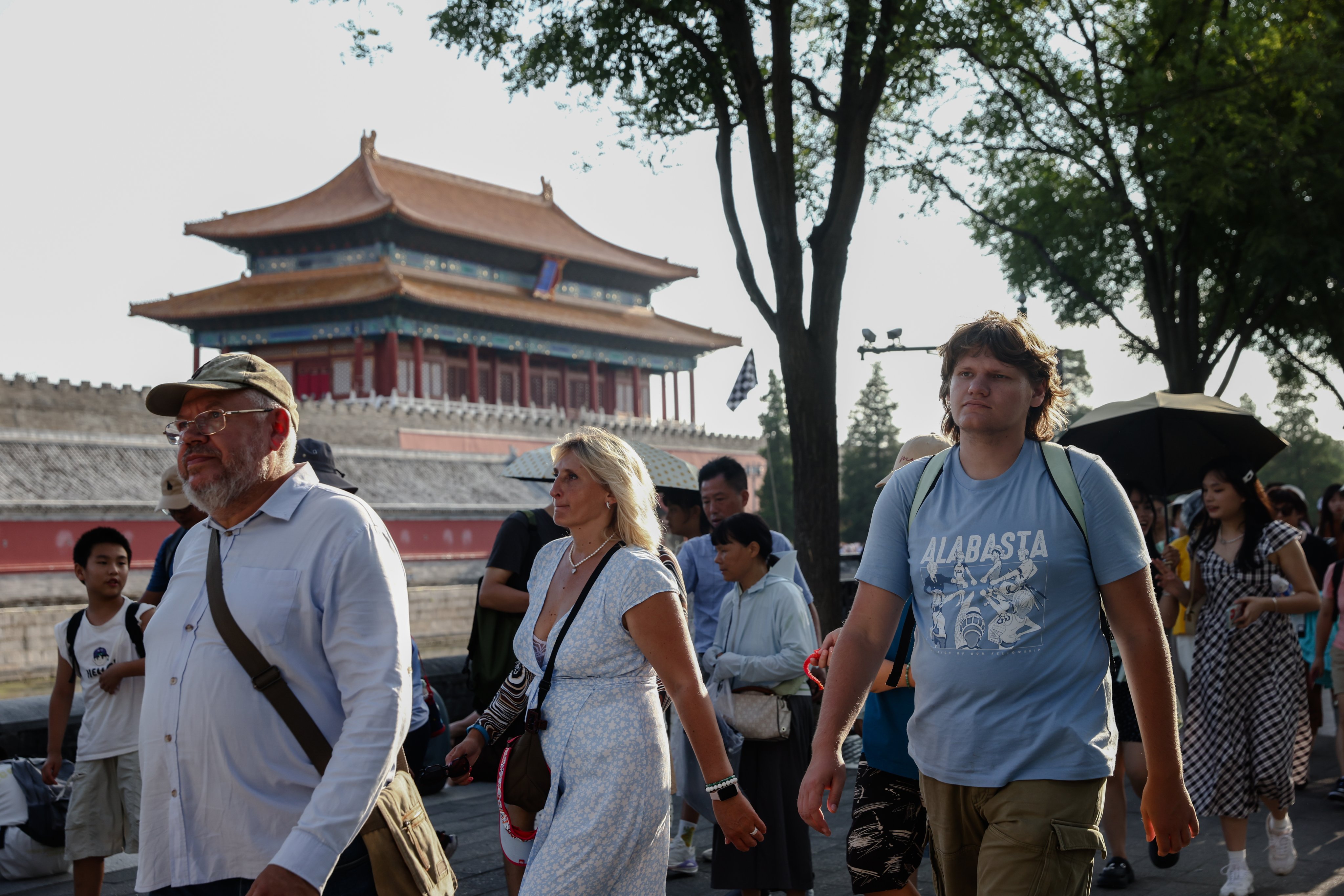 Foreign tourists walk near the Forbidden City in Beijing on August 13. According to the National Immigration Administration, the country recorded about 14.6 million entries by foreign tourists in the first half of 2024, an increase of more than 150 per cent year on year. Photo: EPA-EFE