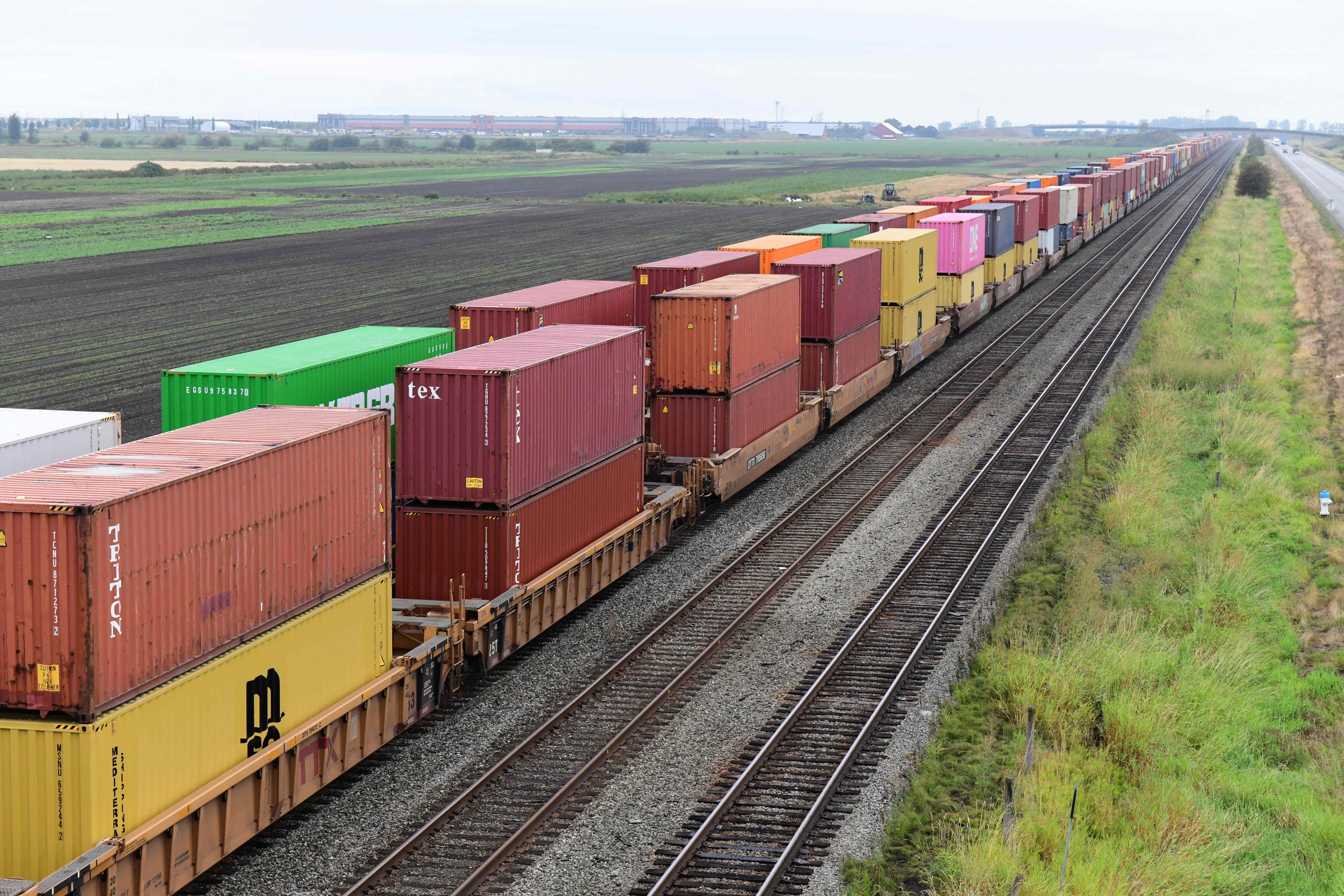 Railway freight trucks loaded with shipping containers sit idle near Roberts Bank Superport in Delta, British Columbia, on August 23, amid Canadian railway labour disputes. Photo: AFP 