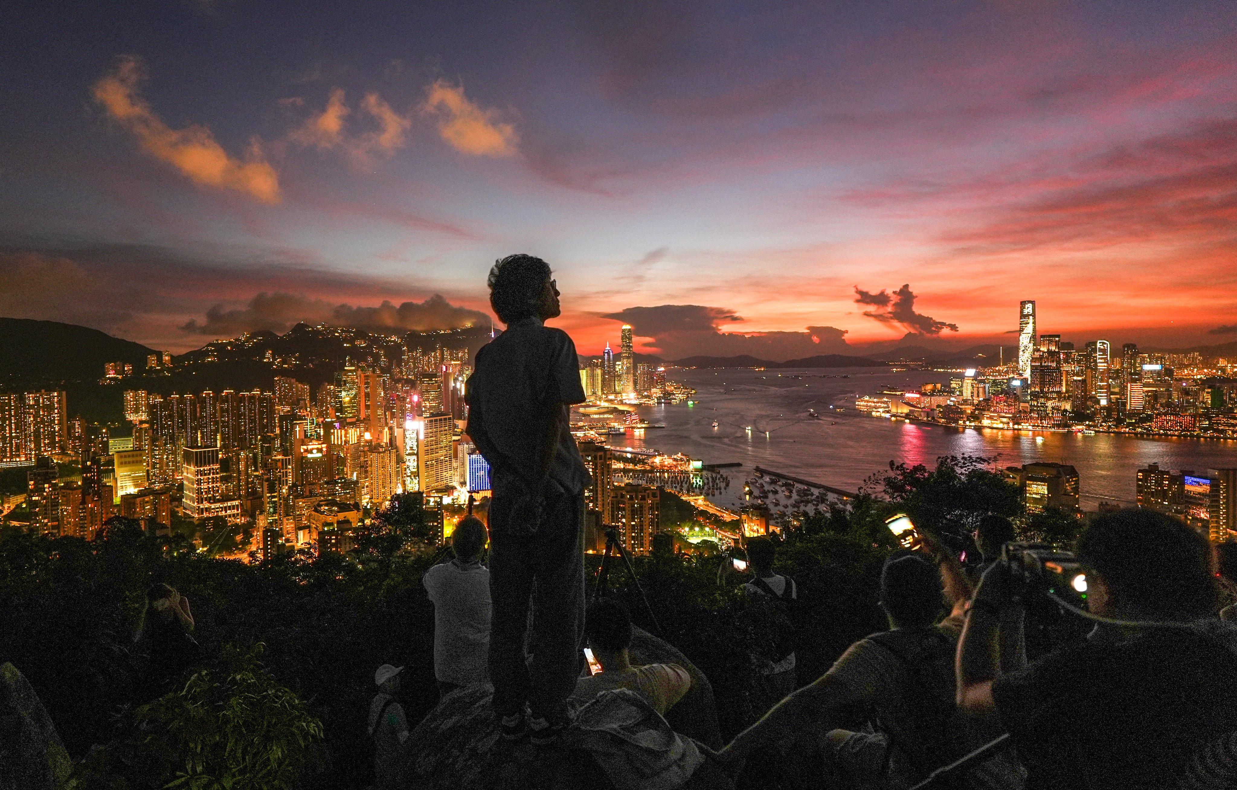 Residents and tourists enjoy the sunset at Red Incense Burner Summit in North Point on July 23. Photo: Eugene Lee