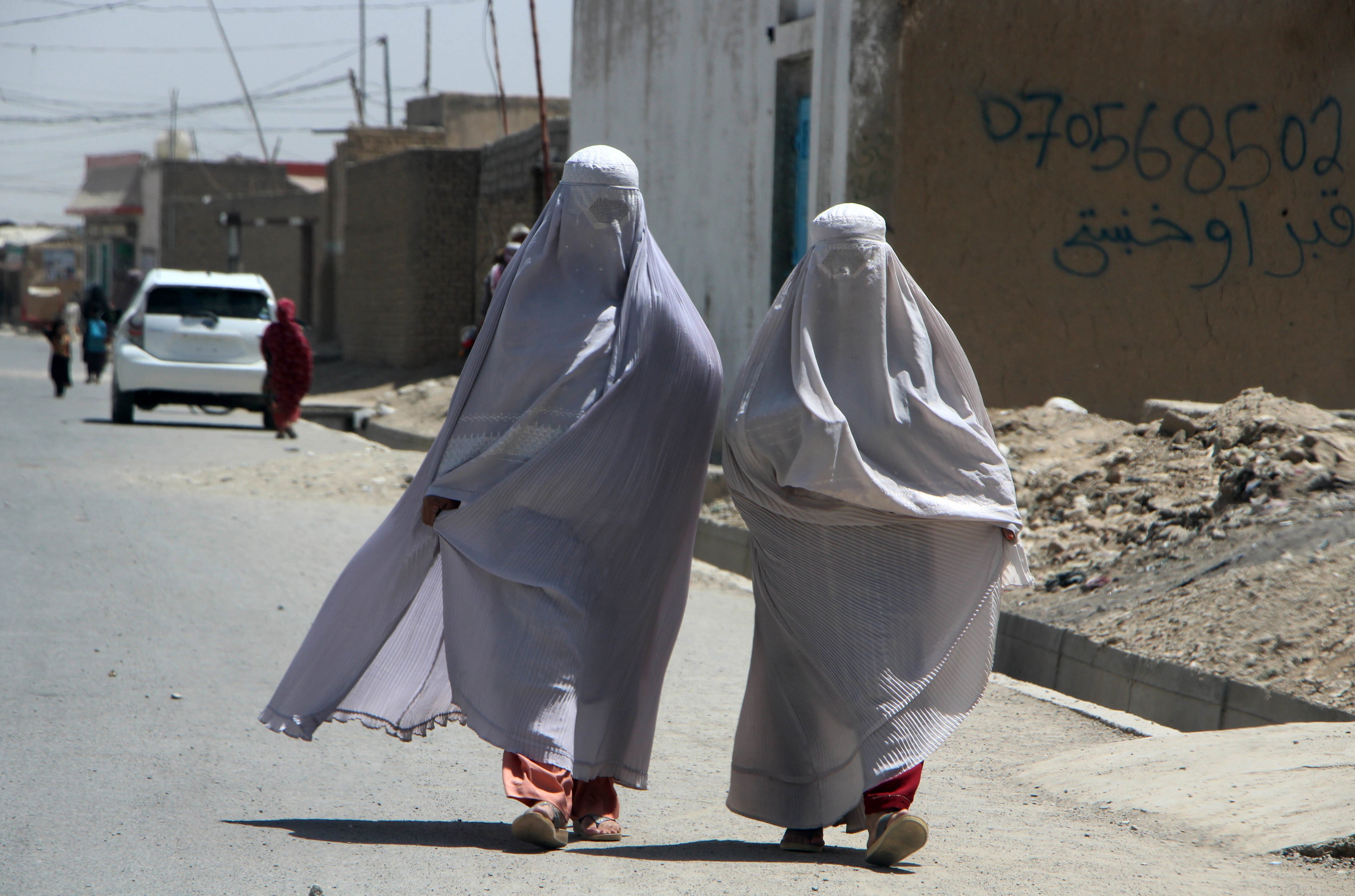 Burka-clad Afghan women walk on a road in Kandahar, Afghanistan. Photo: EPA-EFE