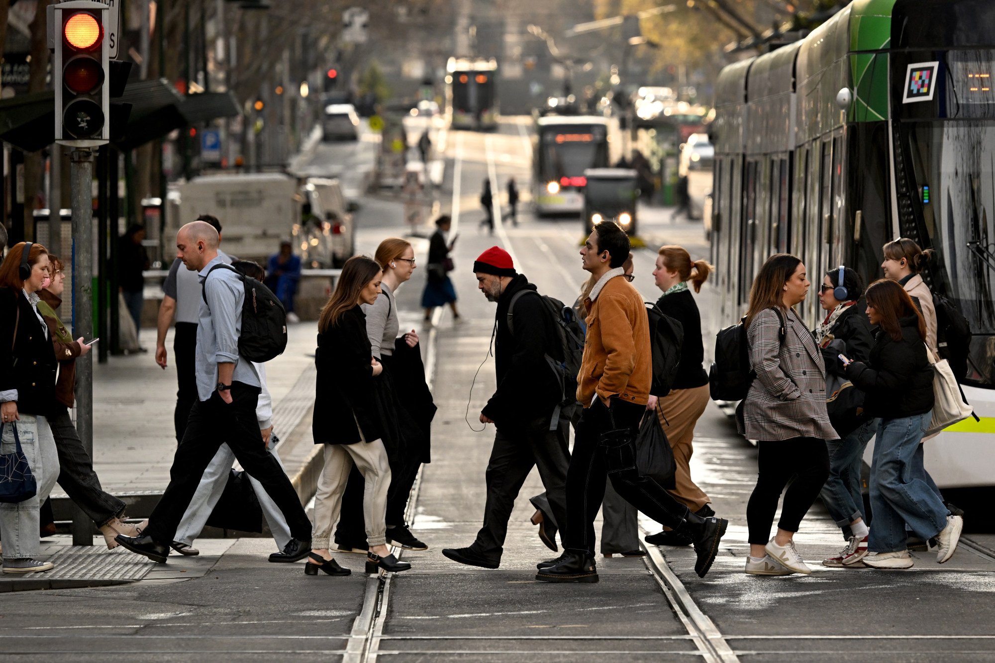 People cross a street in Melbourne’s central business district. A new “right to disconnect” law came into force in Australia on Monday. Photo: AFP