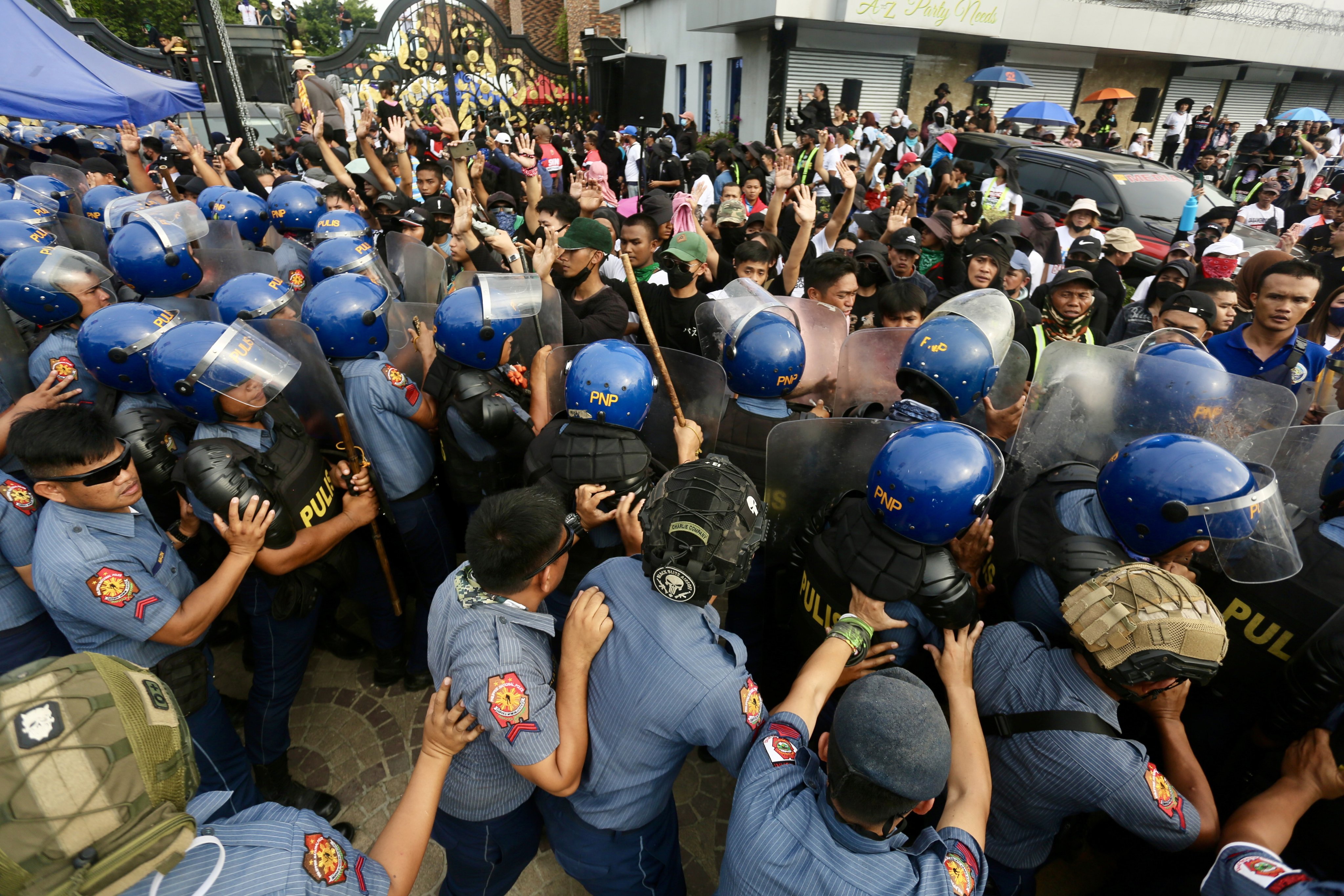 Anti-riot police block supporters of religious leader Apollo Quiboloy as they stage a protest rally outside the Kingdom of Jesus Christ compound in Davao City on Monday. Photo: EPA-EFE