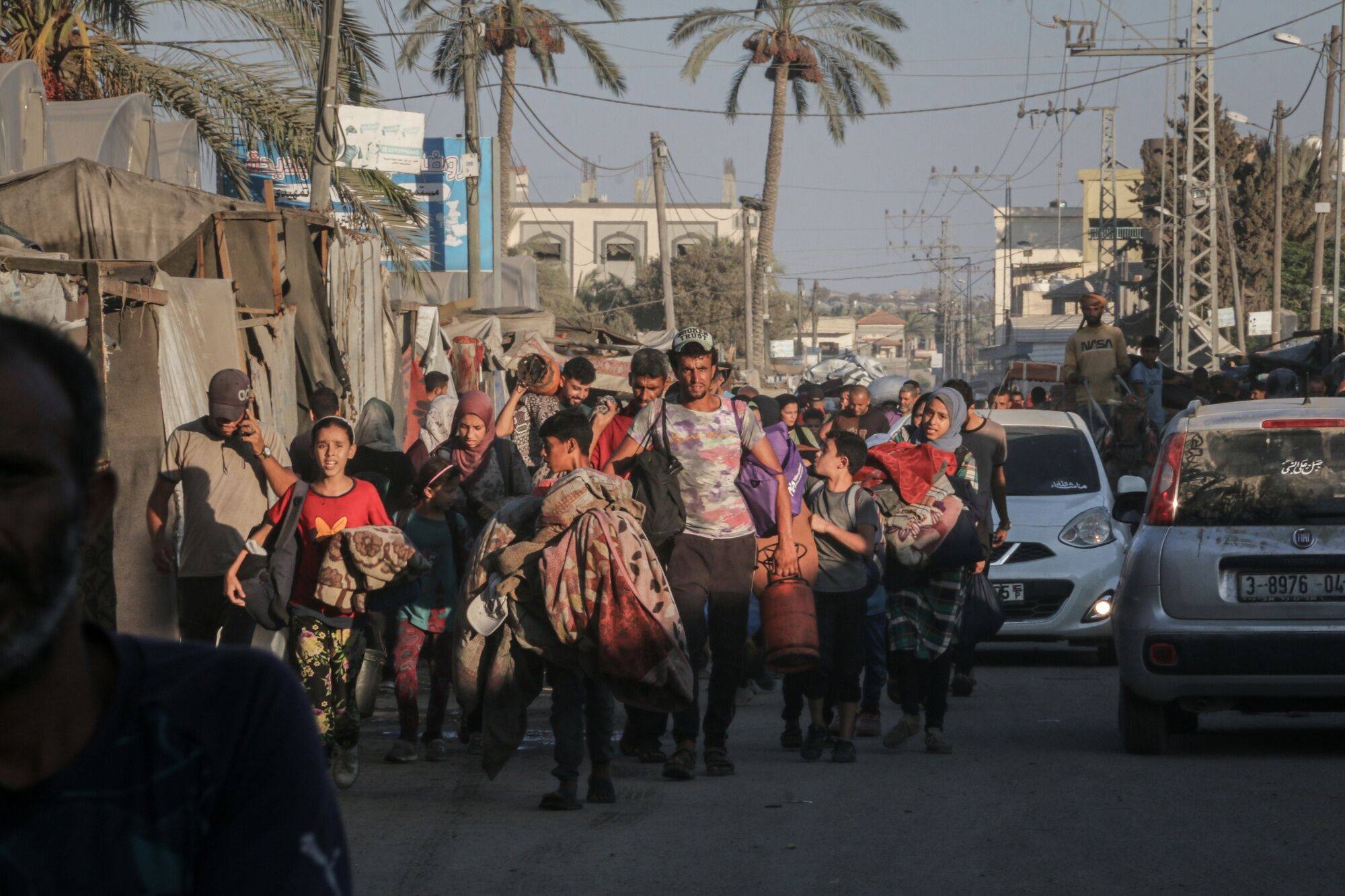 Displaced Palestinians flee a neighbourhood after evacuation orders from the Israeli army in Deir al-Balah, central Gaza, on Sunday. Photo: Bloomberg