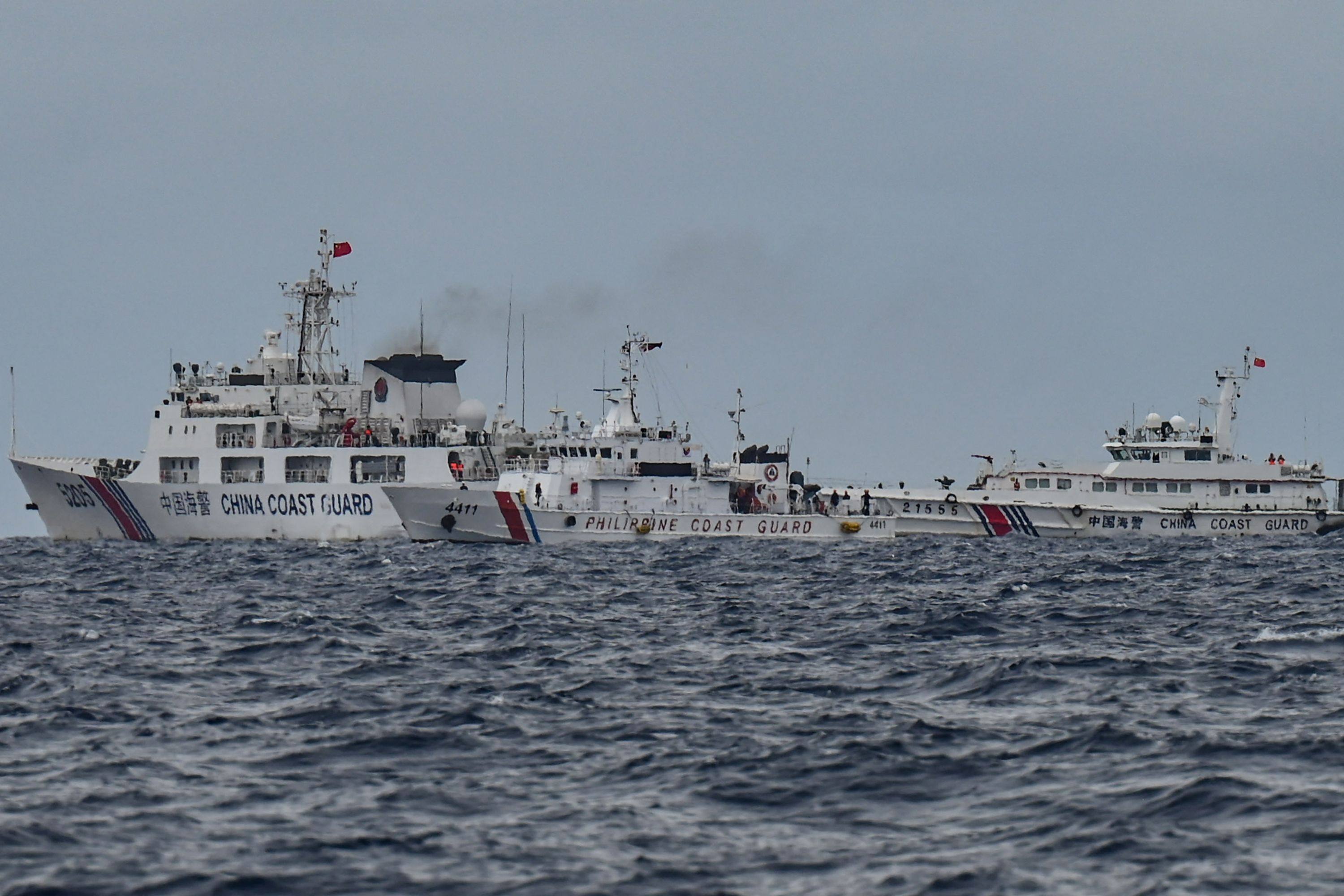 Chinese coastguard ships surround a Philippine patrol vessel near Sabina Shoal in the South China Sea on Monday. Photo: AFP