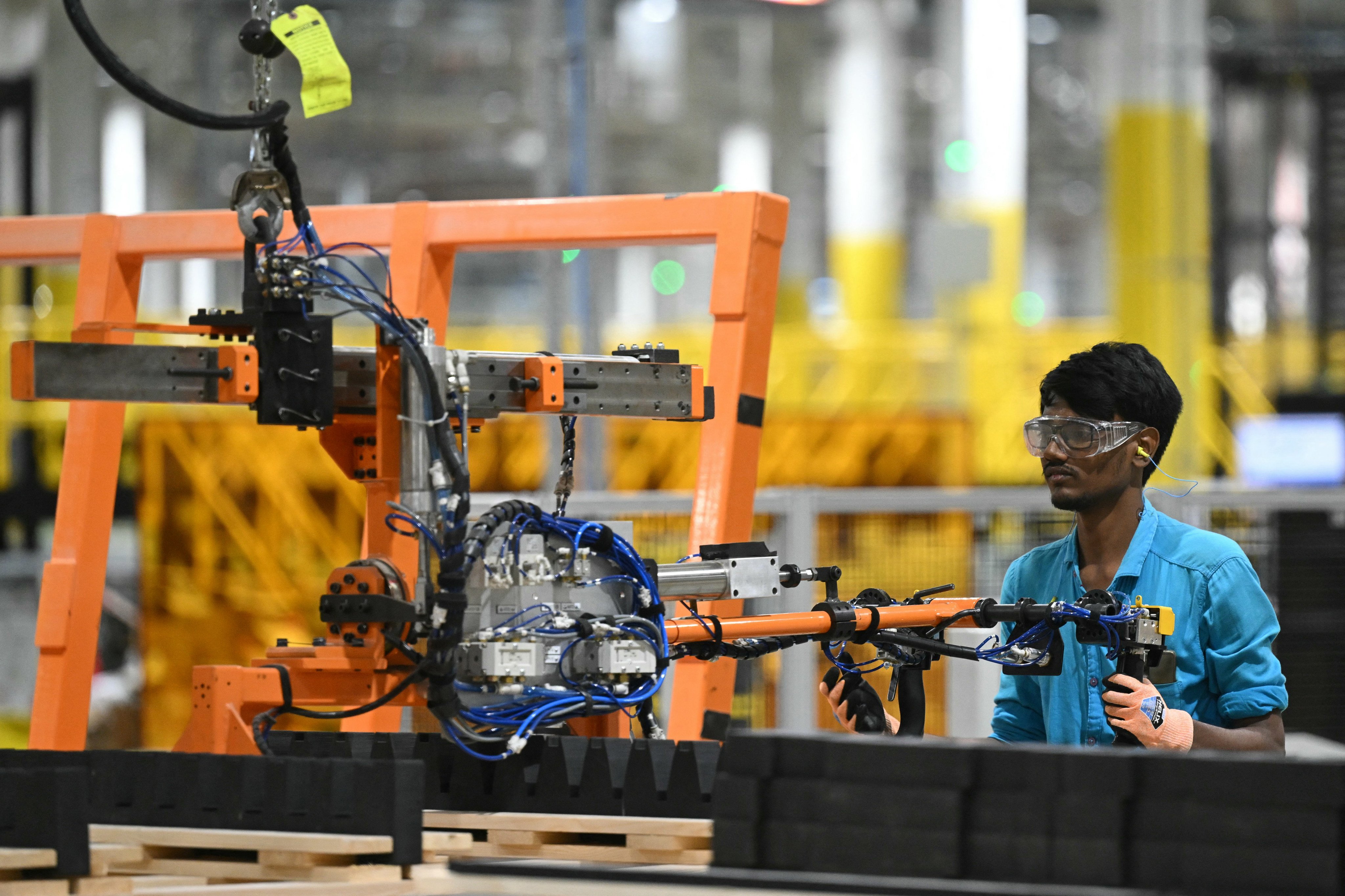 A worker operates a machine at the First Solar manufacturing facility in Sriperumbudur, Kanchipuram district. Photo: AFP