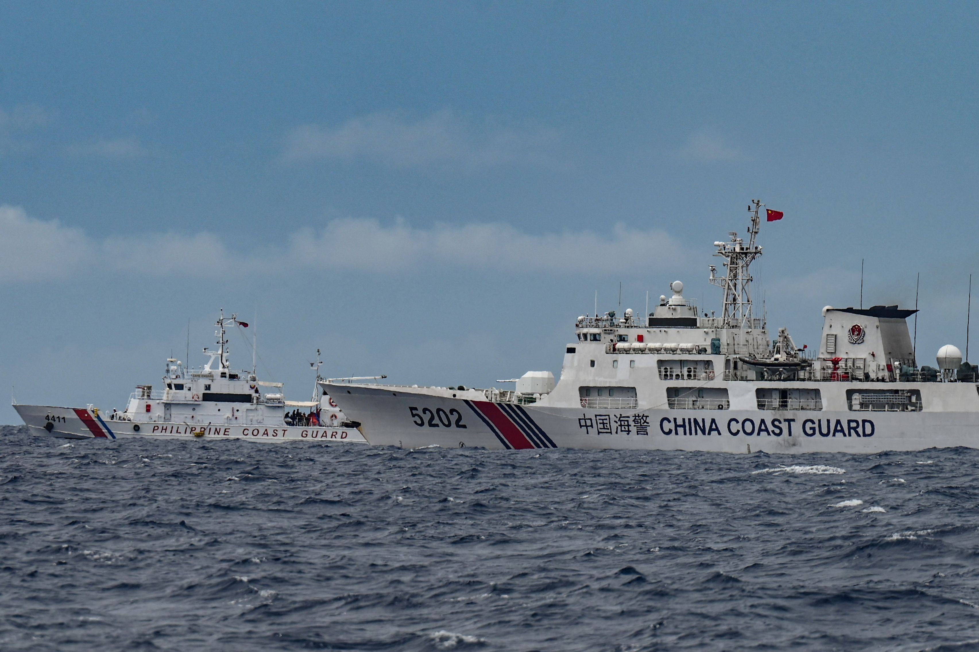 A Chinese coastguard ship and a Philippine coastguard ship sailing near Sabina Shoal in the South China Sea. Photo: AFP