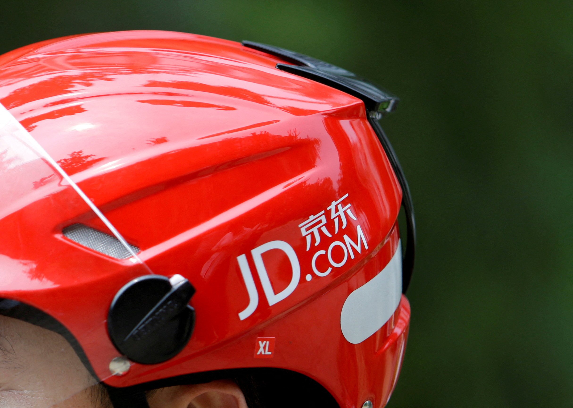 A JD.com logo seen on the helmet of a delivery person in Beijing. Photo: Reuters