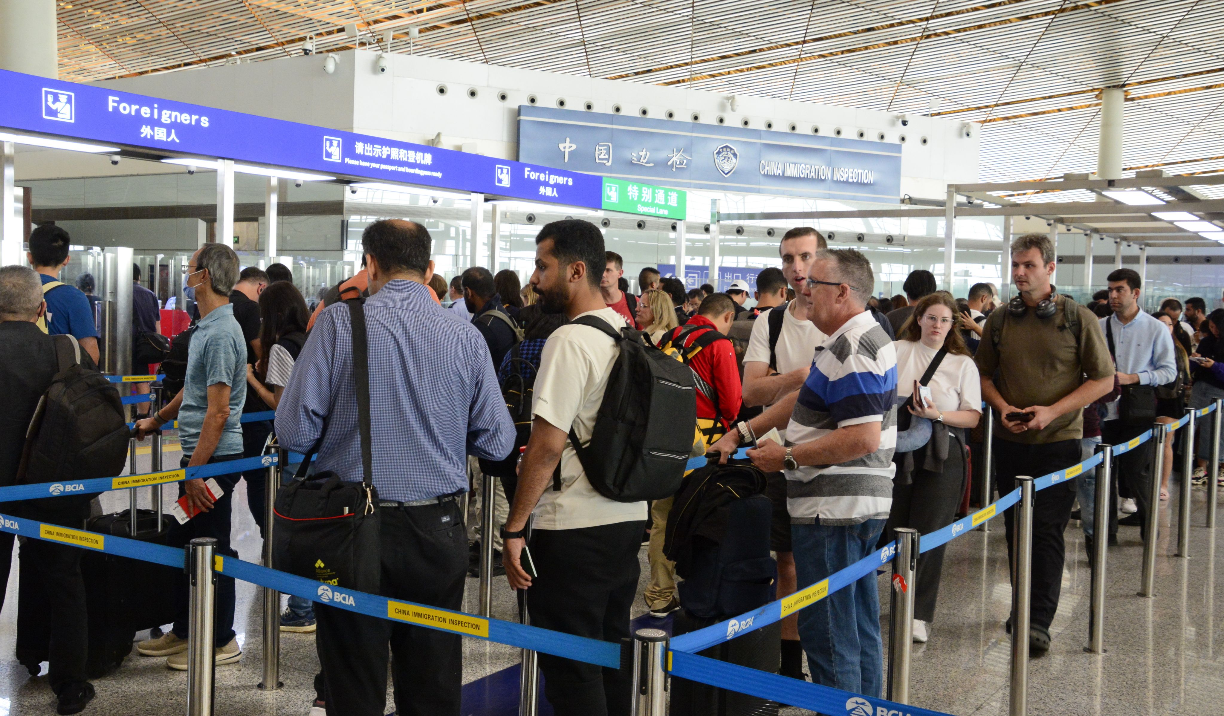 Foreign passengers enter the border check section of Beijing Capital International Airport in Beijing. Photo: Xinhau