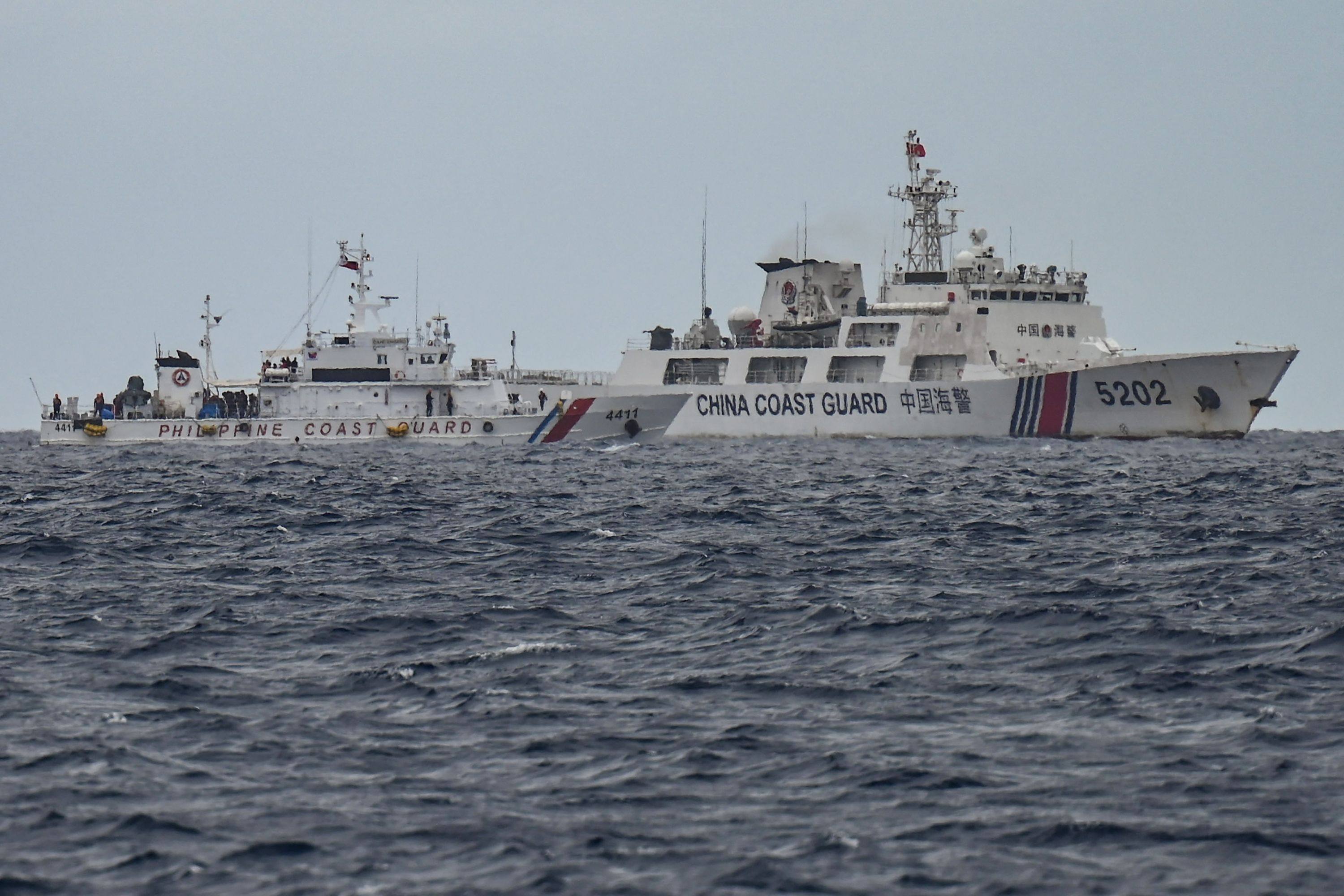 A Chinese coastguard ship passes a Philippine vessel during a resupply mission to Sabina Shoal in disputed waters of the South China Sea on Monday. Photo: AFP